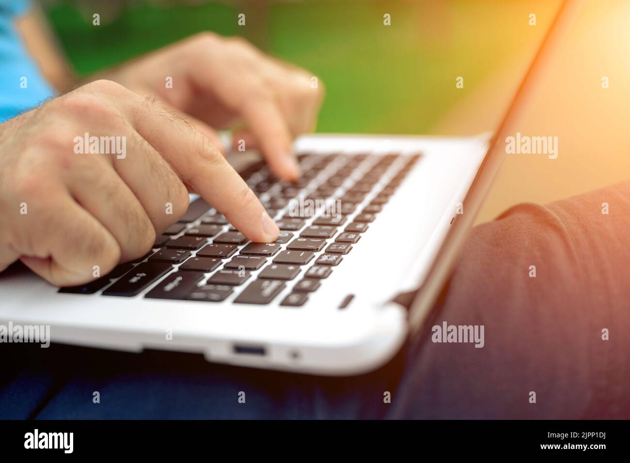 Close-up shot of handsome man's hands touching laptop computer's screen ...