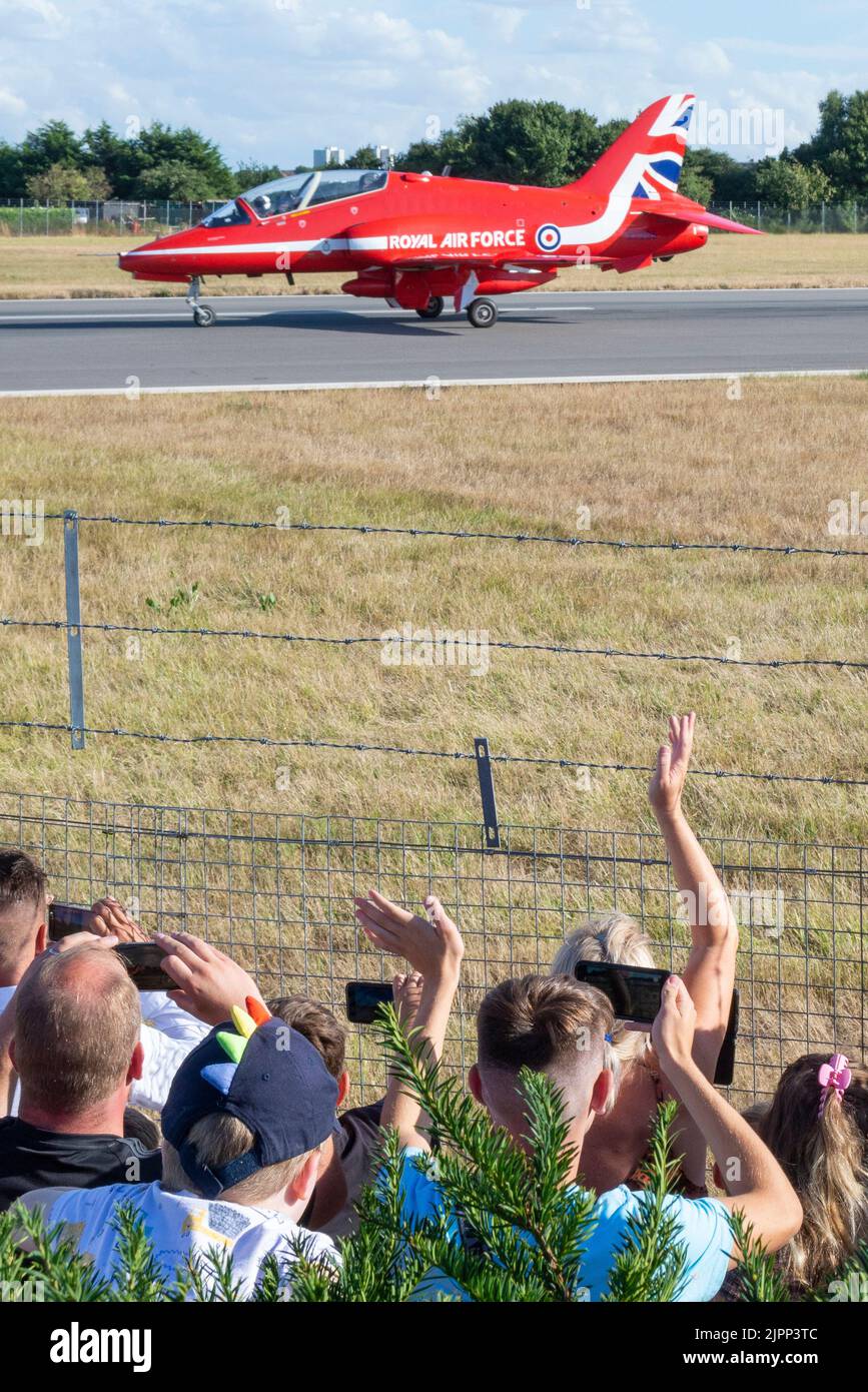 London Southend Airport, Essex, UK. 19th Aug, 2022. The RAF’s Red Arrows are using the civilian airport to operate from for this weekend’s airshows at Eastbourne and Folkestone. The Red Arrows have arrived this evening, arriving in their famous arrow formation before breaking to land. Many people have come out to see them, lining the fences Stock Photo