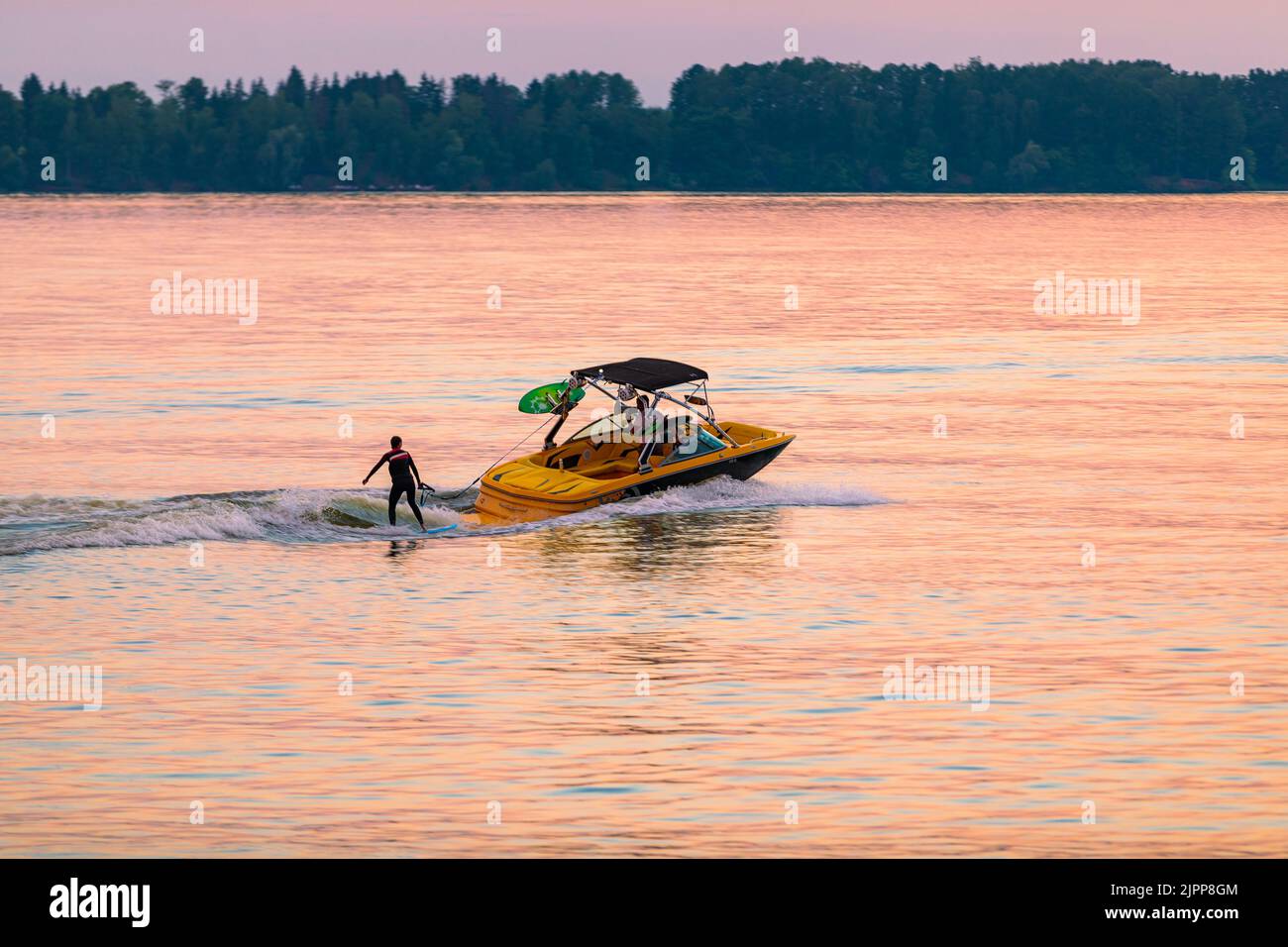 Man driving boat over lake hi-res stock photography and images - Alamy