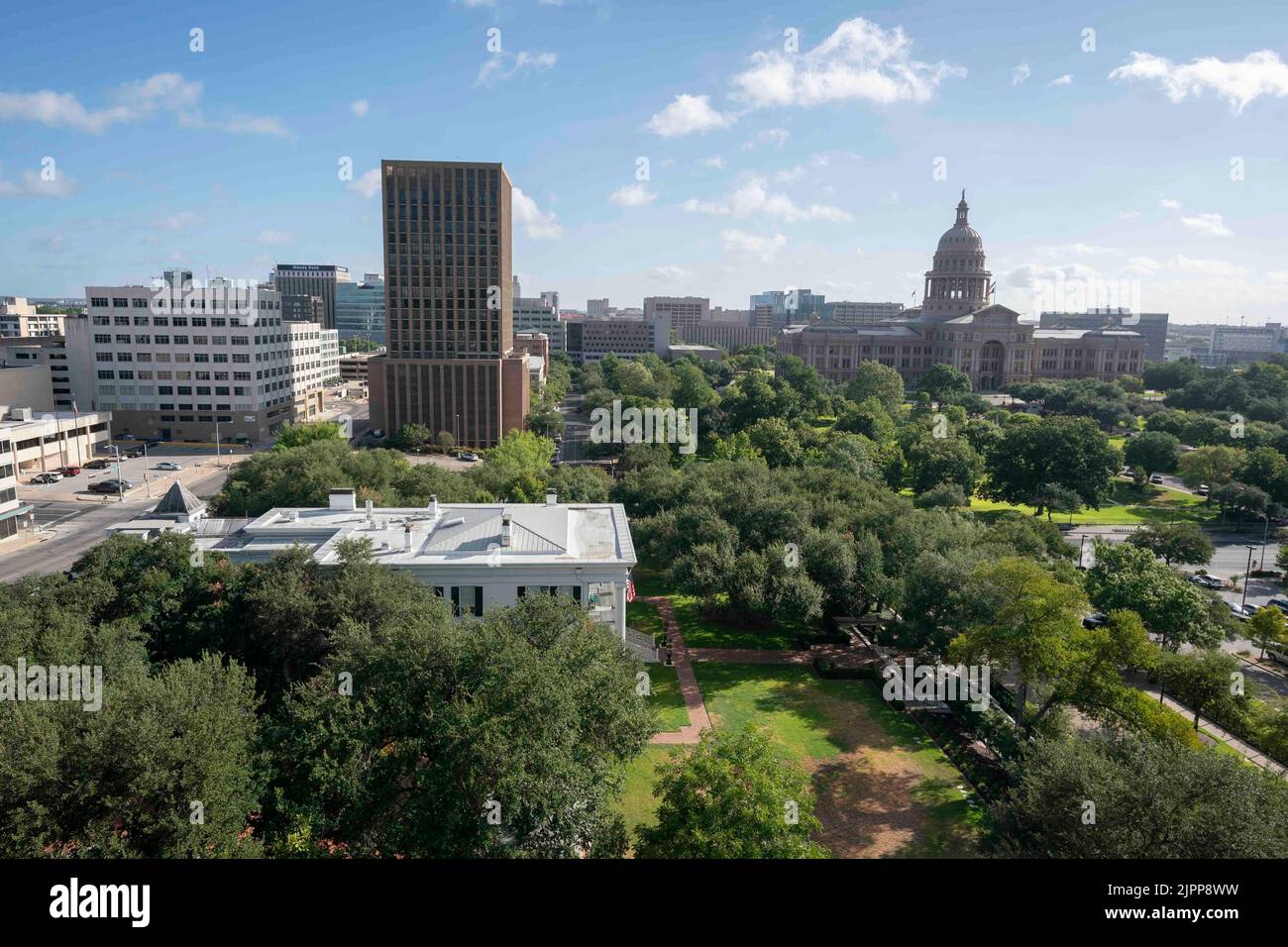 Austin Texas USA, August 2 2022: A view of the Texas Governor's Mansion, near foreground, with the Texas Capitol building behind it to the right in downtown. The Westgate Tower is behind the mansion. ©Bob Daemmrich Stock Photo