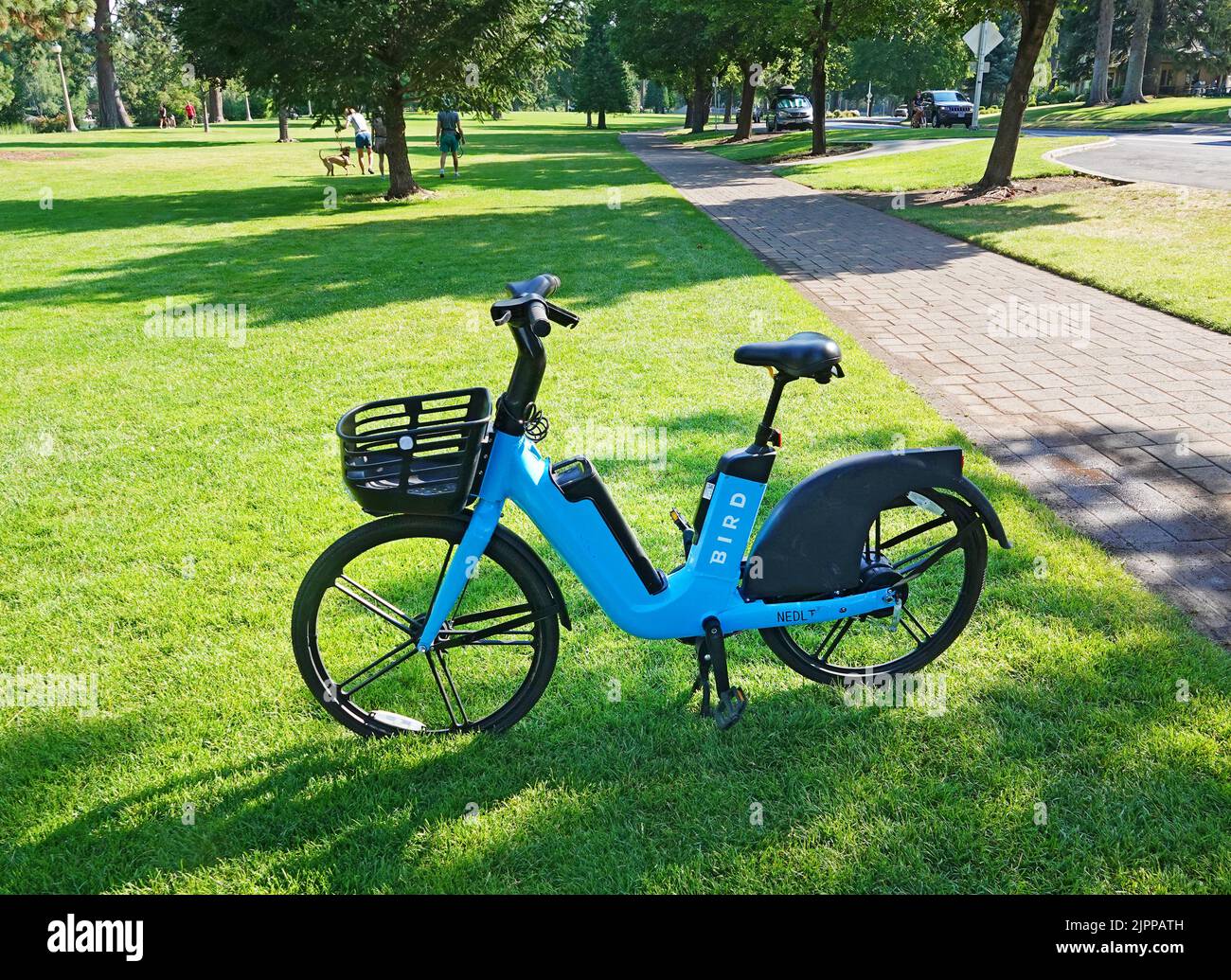 An electric rental bicycle parked in a city park in Bend, Oregon. Stock Photo