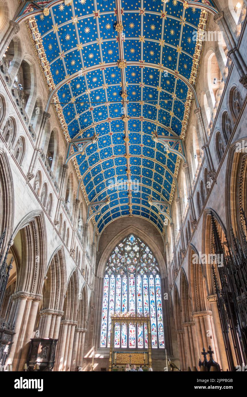 The interior of Carlisle cathedral showing the Owen Jones designed ceiling and the East Window, Cumbria, England, UK Stock Photo