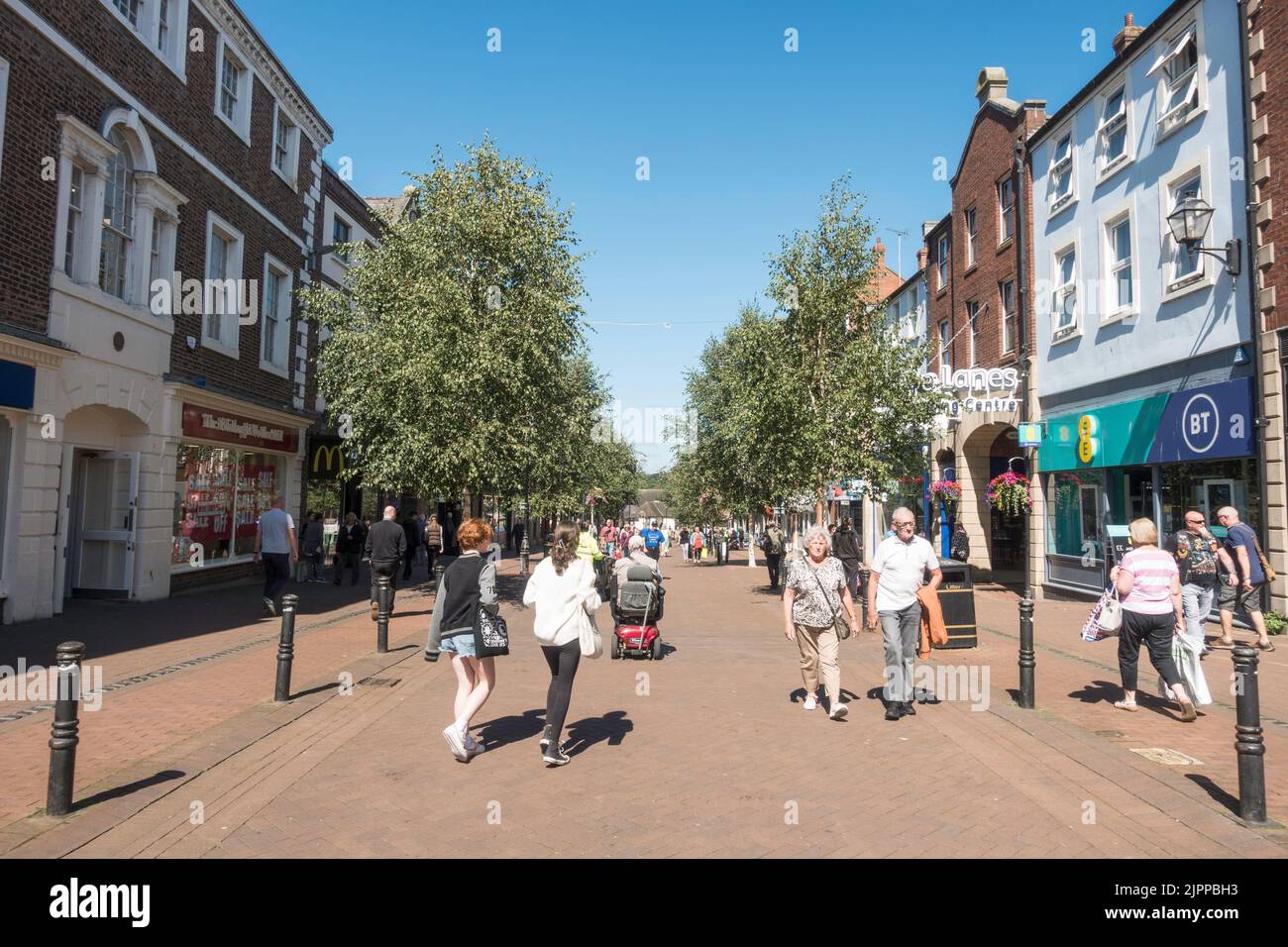 People walking along the pedestrianised Scotch Street in Carlisle city