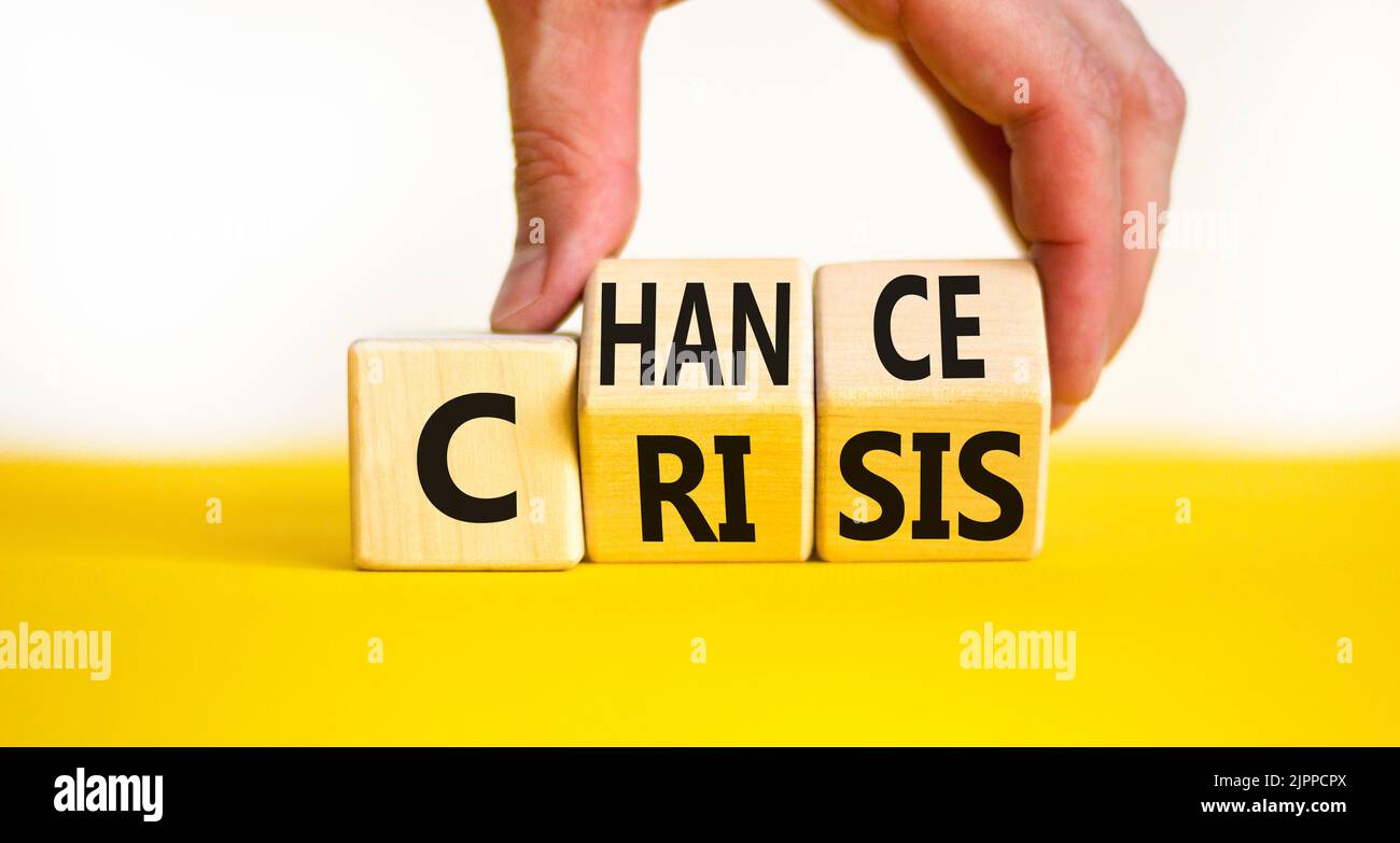 Crisis or chance symbol. Businessman turns wooden cubes and changes the ...