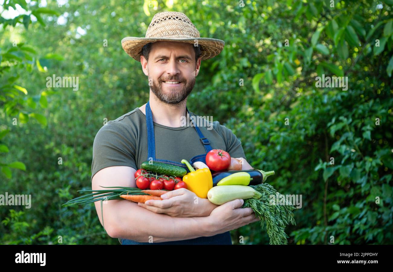 greengrocer in straw hat hold fresh ripe vegetables Stock Photo - Alamy