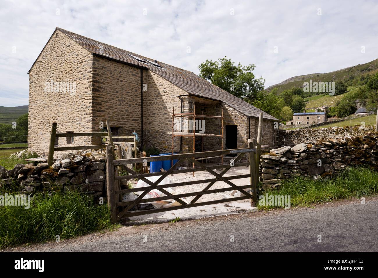 A traditional Yorkshire Dales barn in the process of conversion for residential occupation, Wharfe, near Austwick, Yorkshire Dales National Park. Stock Photo