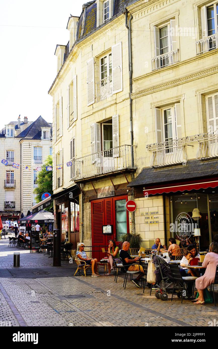 People enjoying coffee and chatting at a cafe in the center of Saumur, Loire valley, France at dusk in the summer Stock Photo