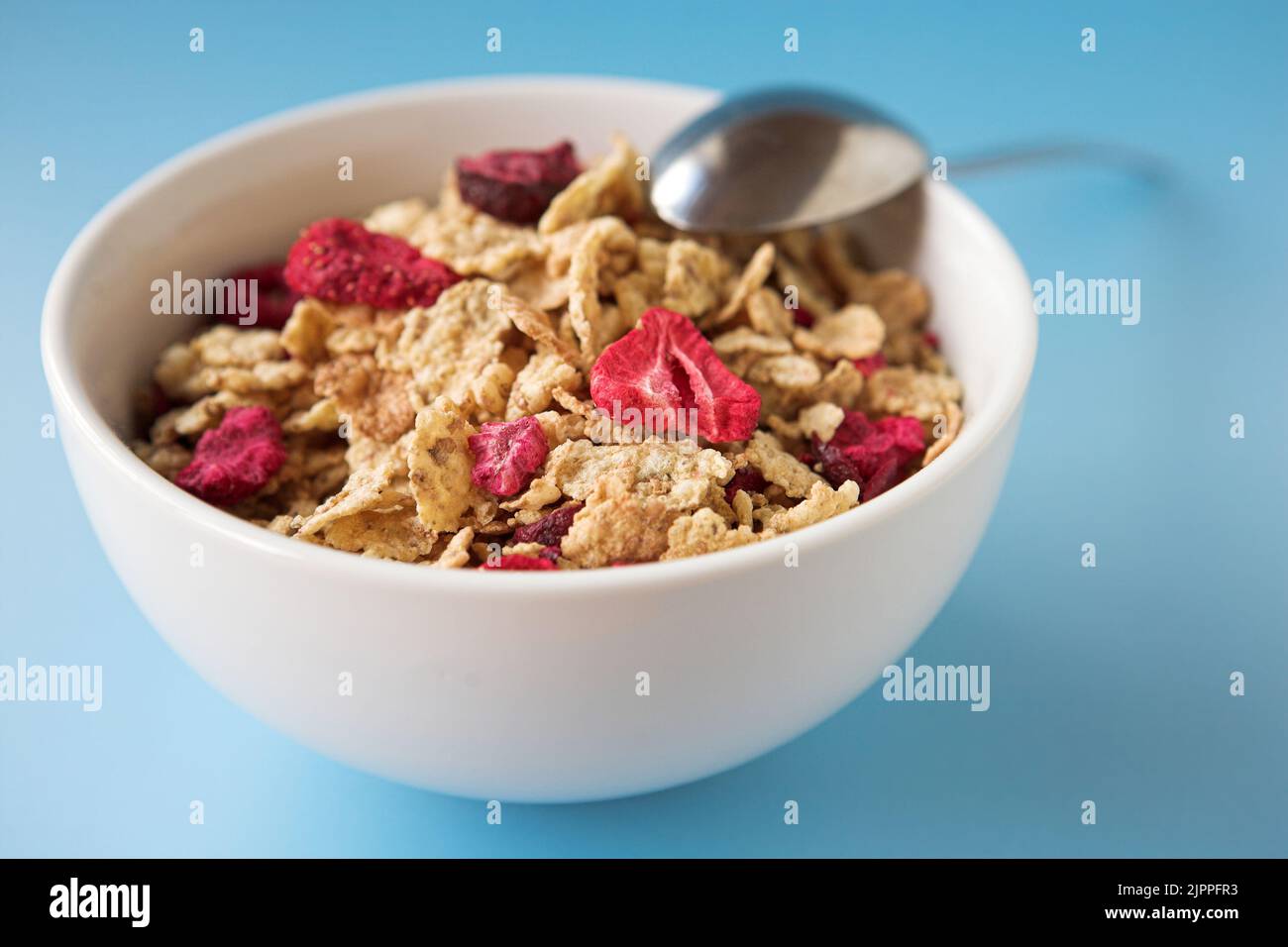 Close up of cereal & fruits on a blue  background - shallow dof Stock Photo