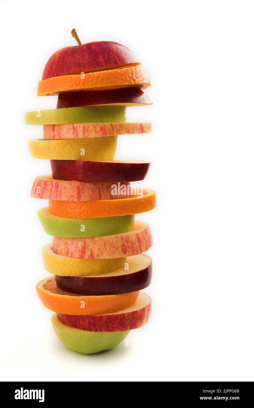 Stacks of sliced fruit (orange, apple & lemon) healthy eating concept - isolated on  white Stock Photo