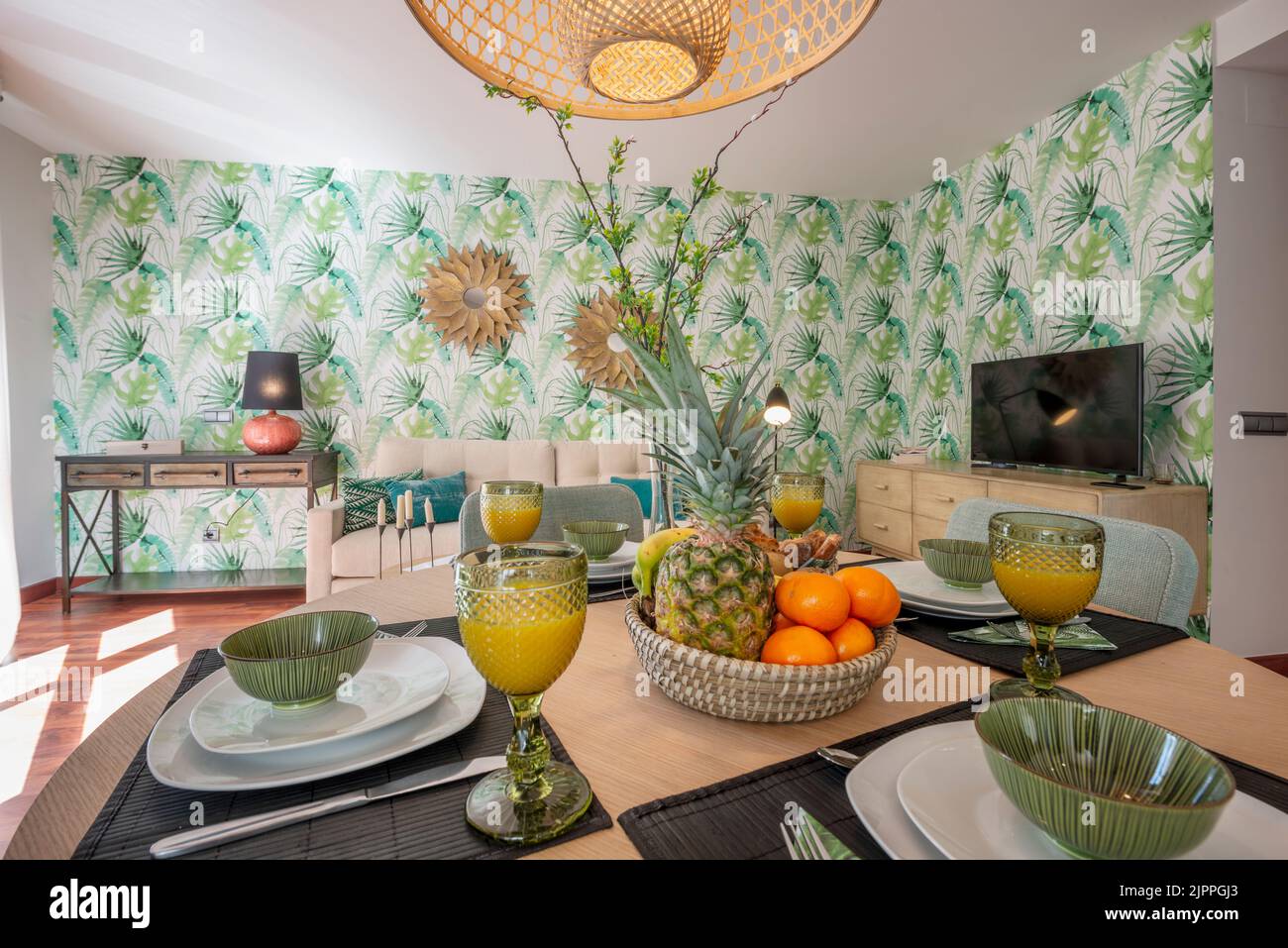 Dining room with wooden table with large breakfast area with fruits ...