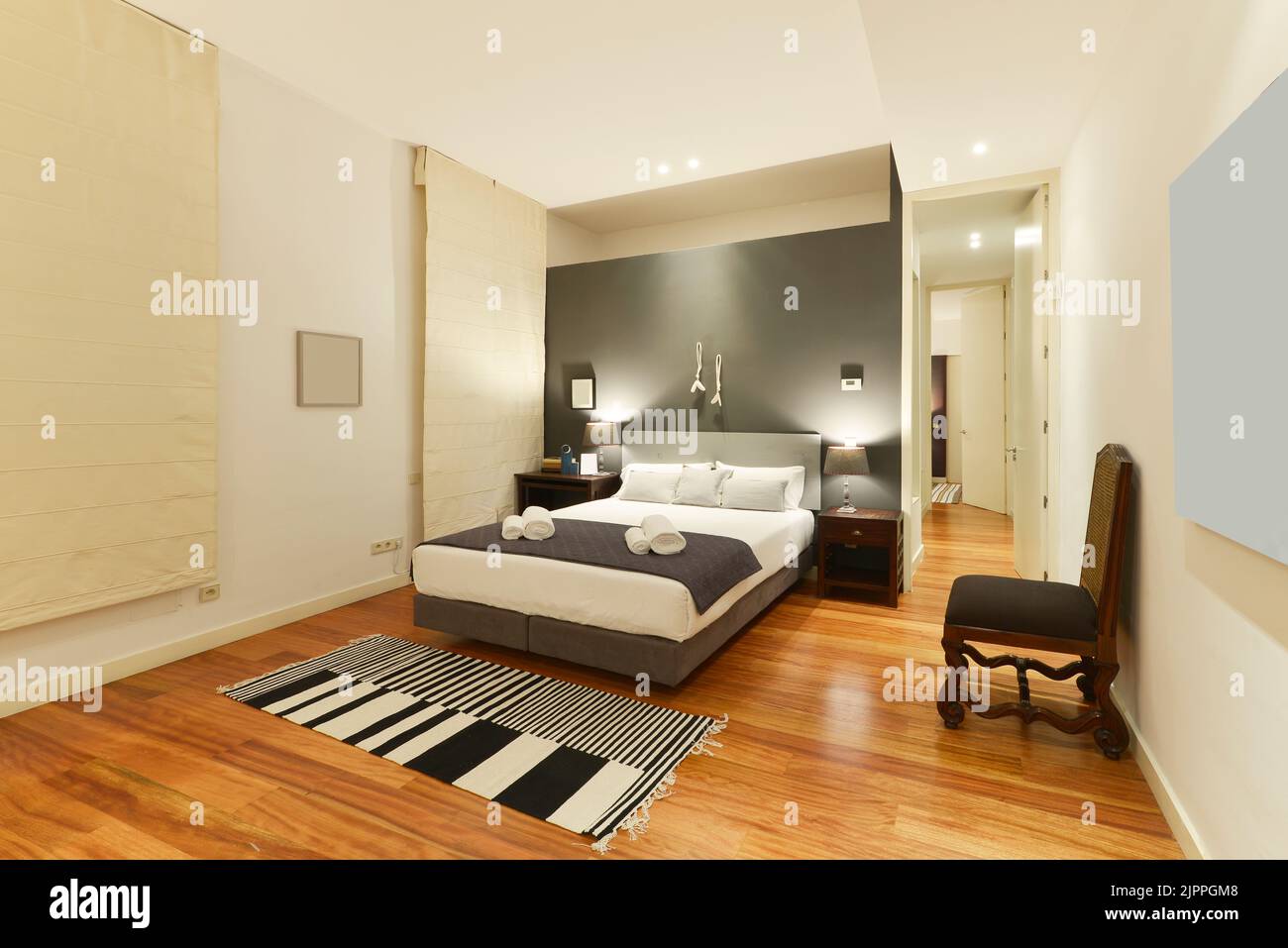 Bedroom decorated in classic vintage style with gray walls, matching headboard and cushions
