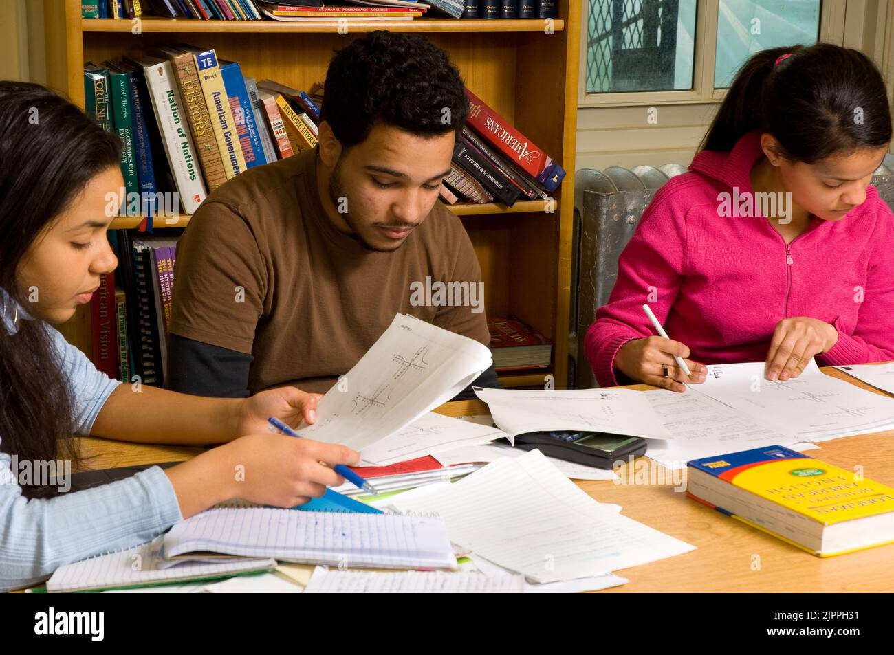 Education High School classroom mathematics or science, male and female students working with graphs or charts during class Stock Photo