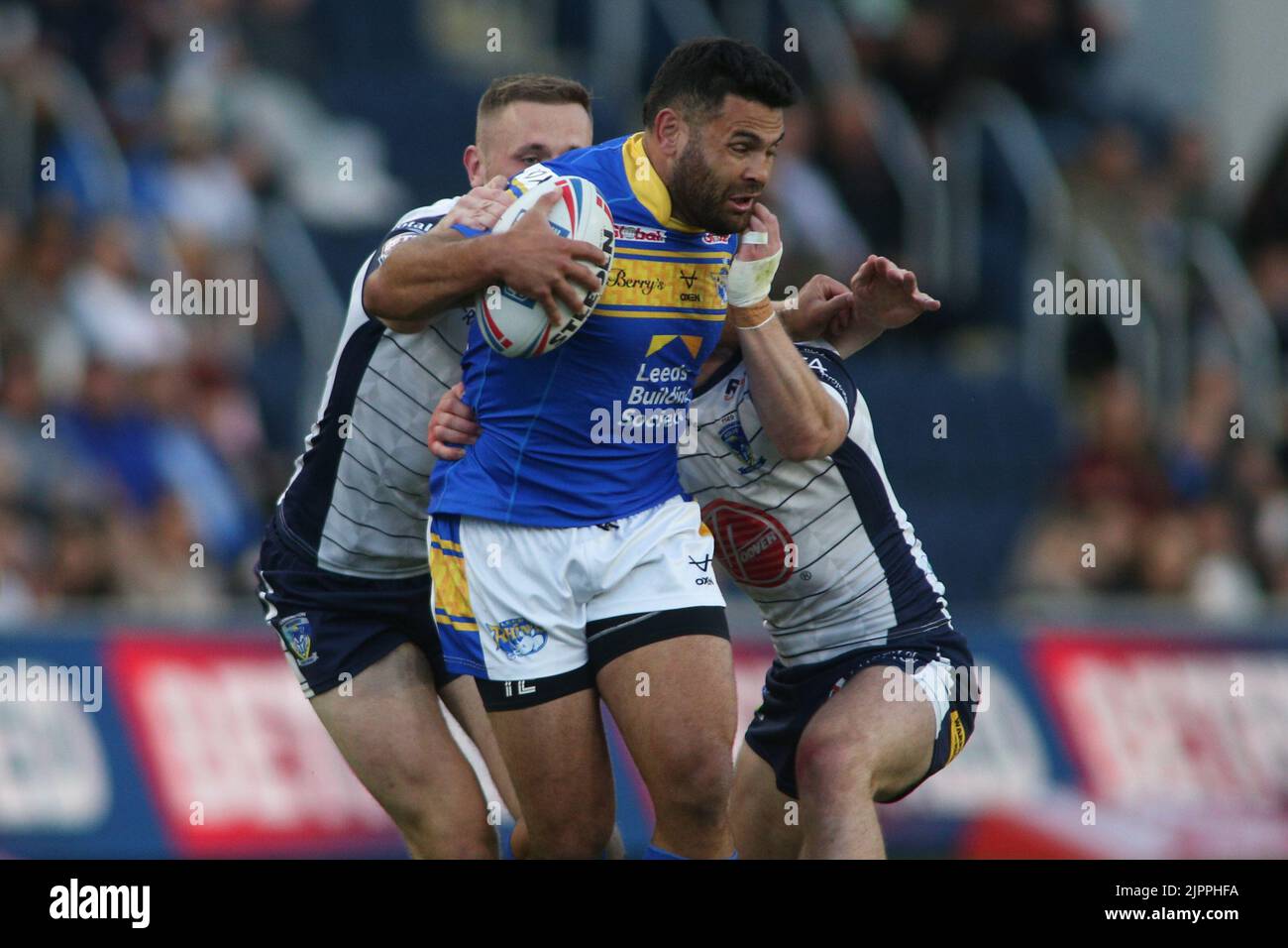 Leeds, UK. 19th Aug, 2022. Headingley Stadium, Leeds, West Yorkshire, 19th August 2022. Betfred Super League Leeds Rhinos v Warrington Wolves Rhyse Martin of Leeds Rhinos tackled by Ben Currie and Danny Walker of Warrington Wolves. Credit: Touchlinepics/Alamy Live News Stock Photo