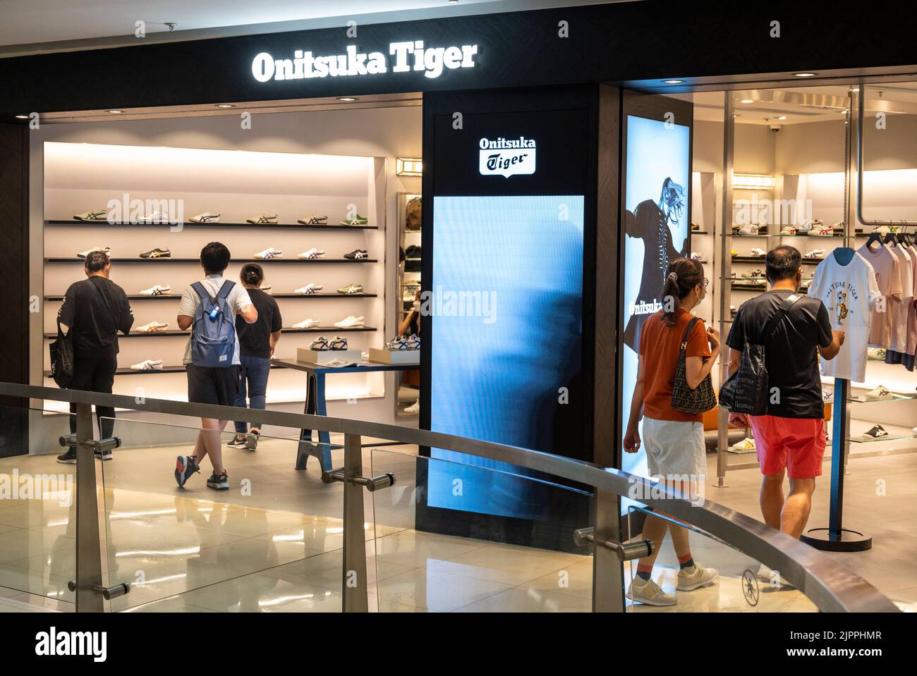 Shoppers are seen at the Japanese sports shoe brand Onitsuka Tiger