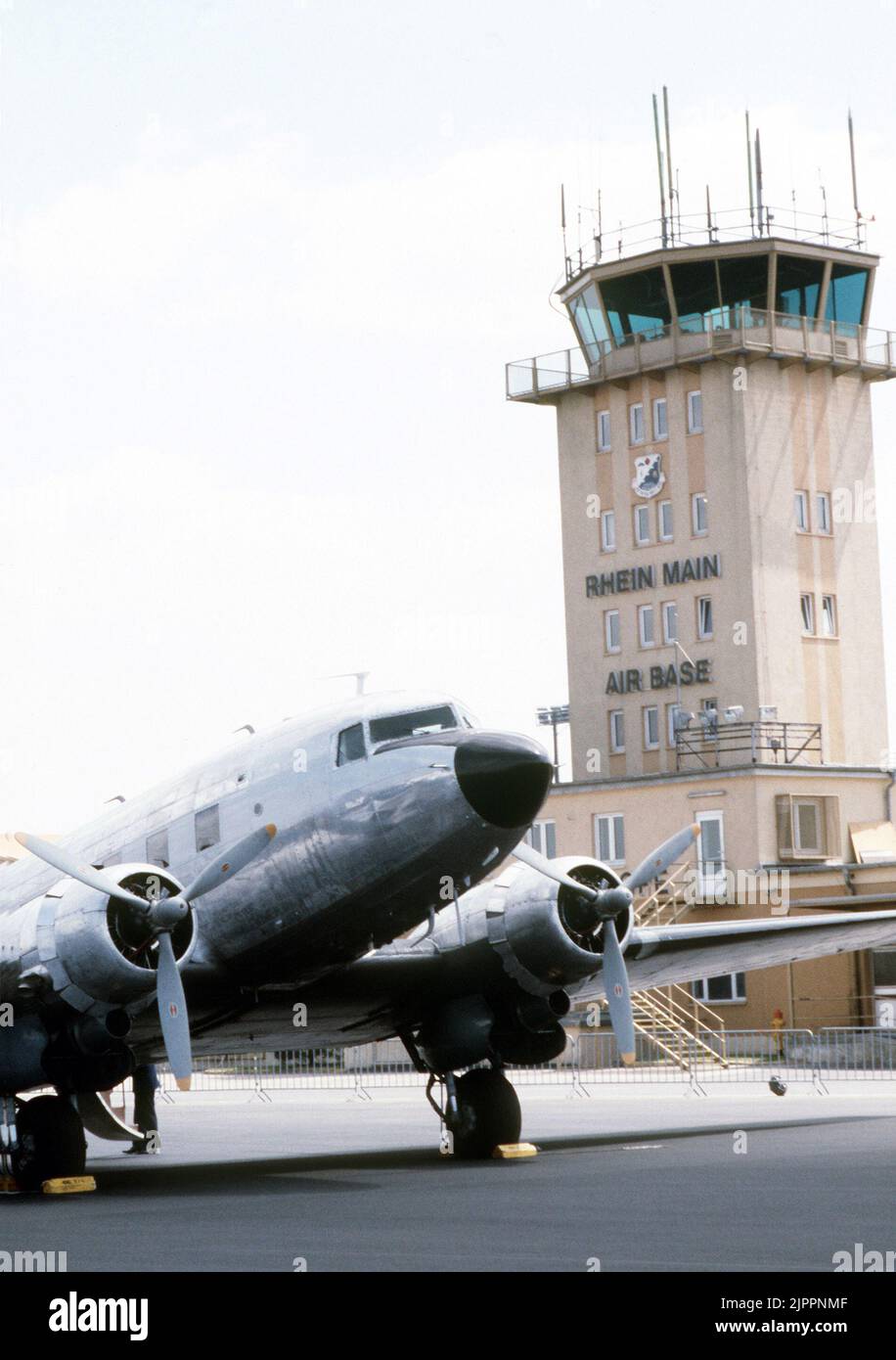 A view of a C-47 Skytrain aircraft parked near the base control tower during ceremonies marking the 40th anniversary of the beginning of the Berlin Airlift. Skytrain aircraft were used extensively to move material during the airlift Stock Photo