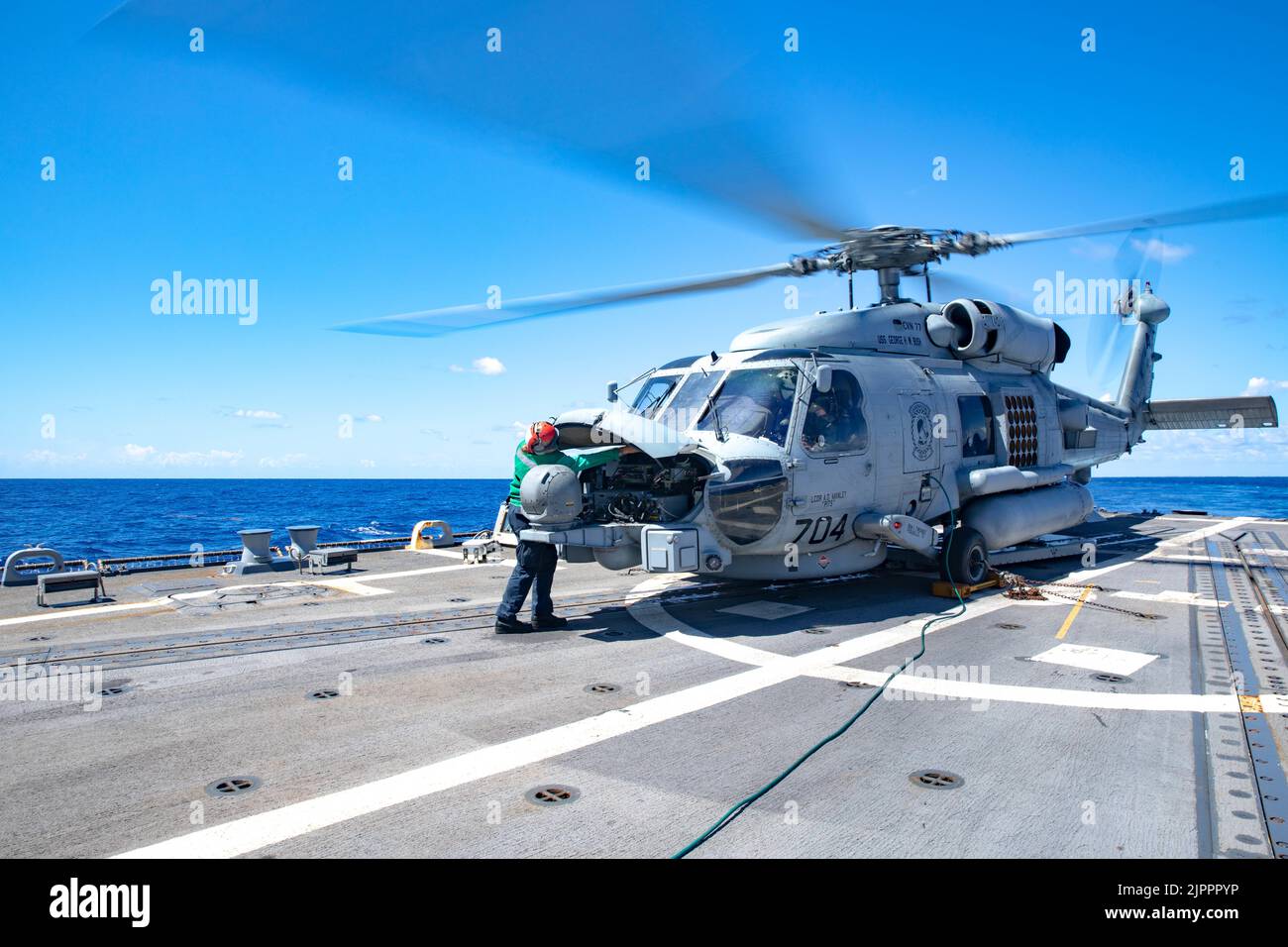 220813-N-OK195-0004 ATLANTIC OCEAN (Aug. 13, 2022) Aircraft Electrician’s Mate 2nd Class Sadie Hernandez performs a maintenance check on an MH-60R Sea Hawk helicopter, attached to Helicopter Maritime Strike Squadron (HSM) 48, on the flight deck aboard the Arleigh Burke-class guided-missile destroyer USS Truxtun (DDG 103), Aug. 13, 2022. Truxtun is part of the George H.W. Bush Carrier Strike Group, an integrated combat weapons system that delivers superior combat capability to deter, and if necessary, defeat America’s adversaries in support of national security. (U.S. Navy photo by Mass Communi Stock Photo