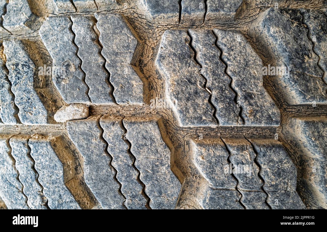 Detail of a section of a tire with a rock stuck between treads Stock