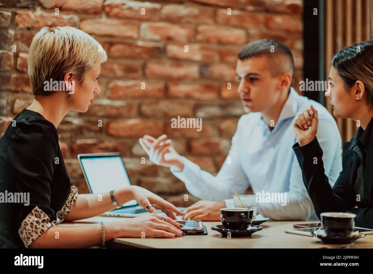 Happy businesspeople smiling cheerfully during a meeting in a coffee