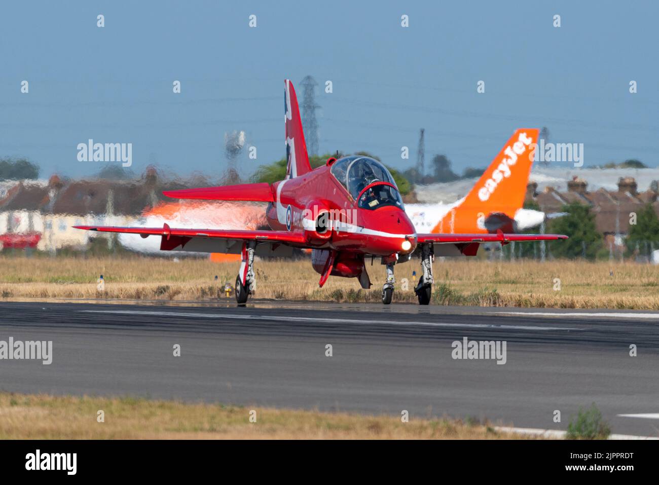 Royal Air Force Red Arrows display team BAe Hawk T.1 jet plane after landing at London Southend Airport for weekend of airshows. easyJet holding Stock Photo