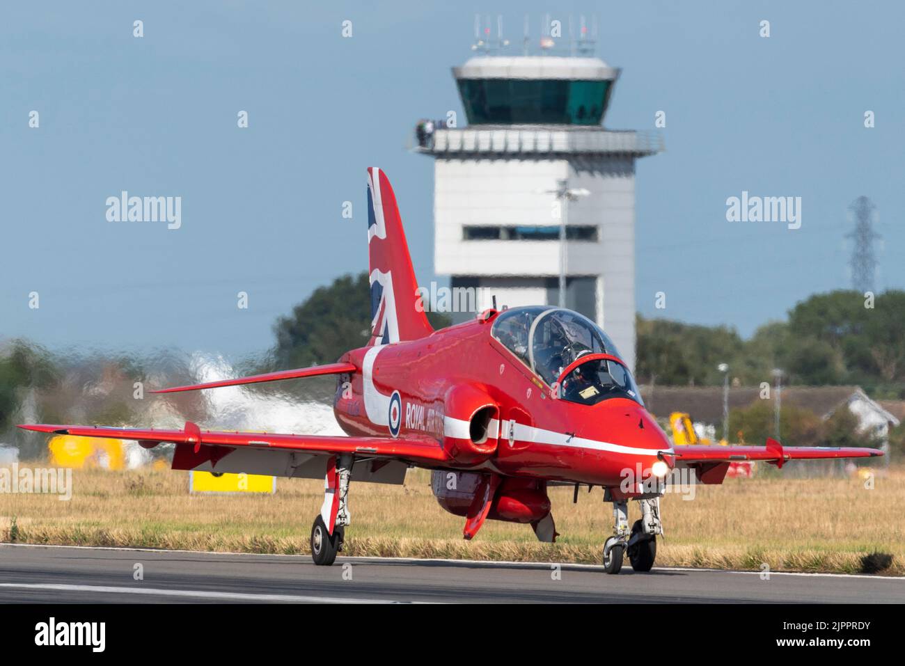 Royal Air Force Red Arrows display team BAe Hawk T.1 jet plane after landing at London Southend Airport for weekend of airshows. Air Traffic tower Stock Photo