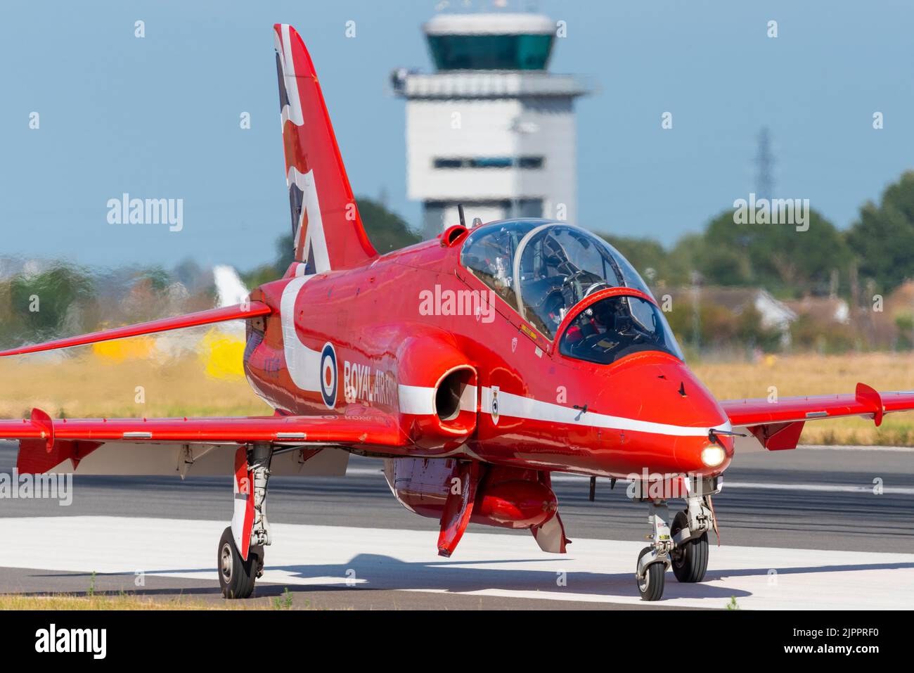 Royal Air Force Red Arrows display team BAe Hawk T.1 jet plane after landing at London Southend Airport for weekend of airshows. Air Traffic tower Stock Photo