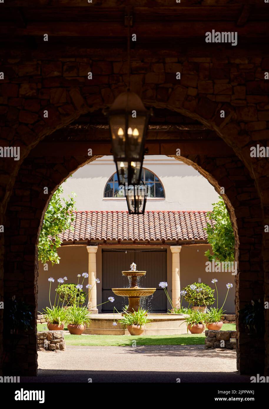 A vertical shot of a small fountain in a garden of the Waterford Wine Estate winery Stock Photo