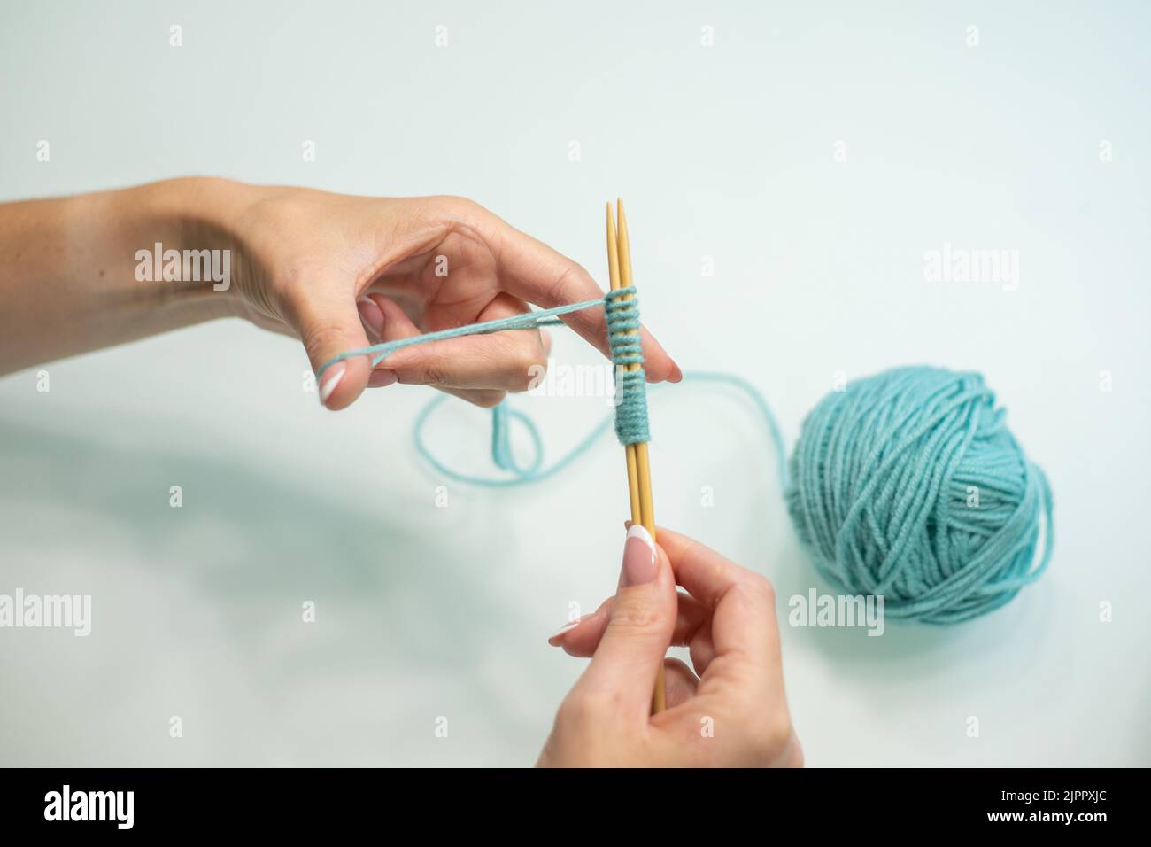 set of loops on the needles step by step. wool and cotton knitting
