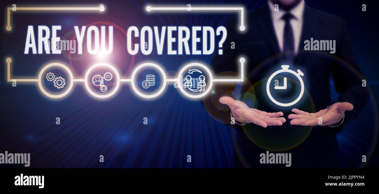Text sign showing Are You Covered, Business concept Asking about how medications are covered by your plan Businessman in suit holding notepad symboliz Stock Photo