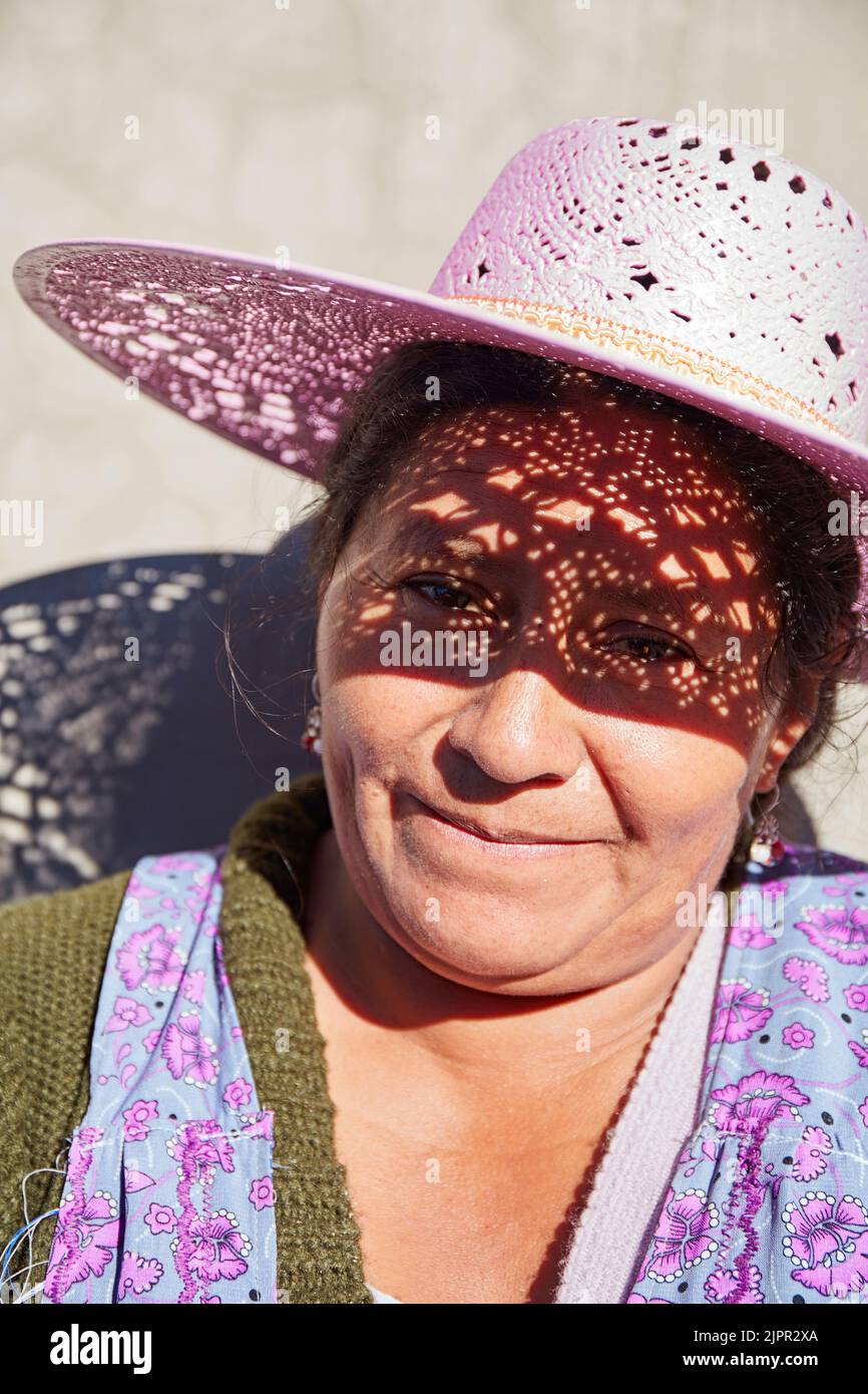 Portrait of a Bolivian woman with a pink hat, Uyuni Salt Flat, Potosi, Bolivia. Stock Photo