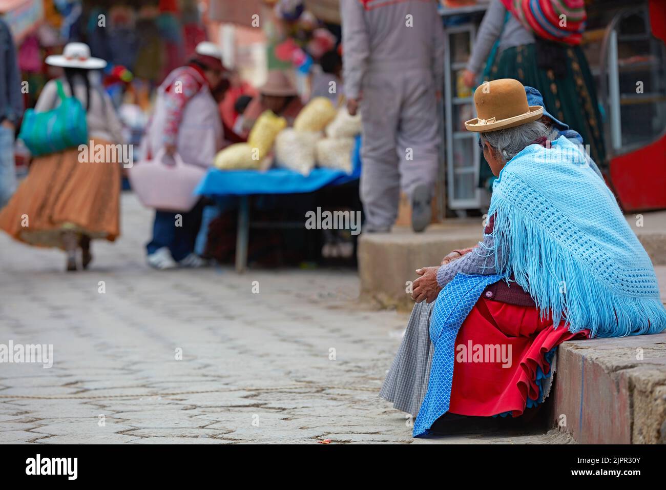 Bolivian Cholas women chatting in a street of Copacabana, Lake Titicaca, La Paz province, Bolivia. Stock Photo