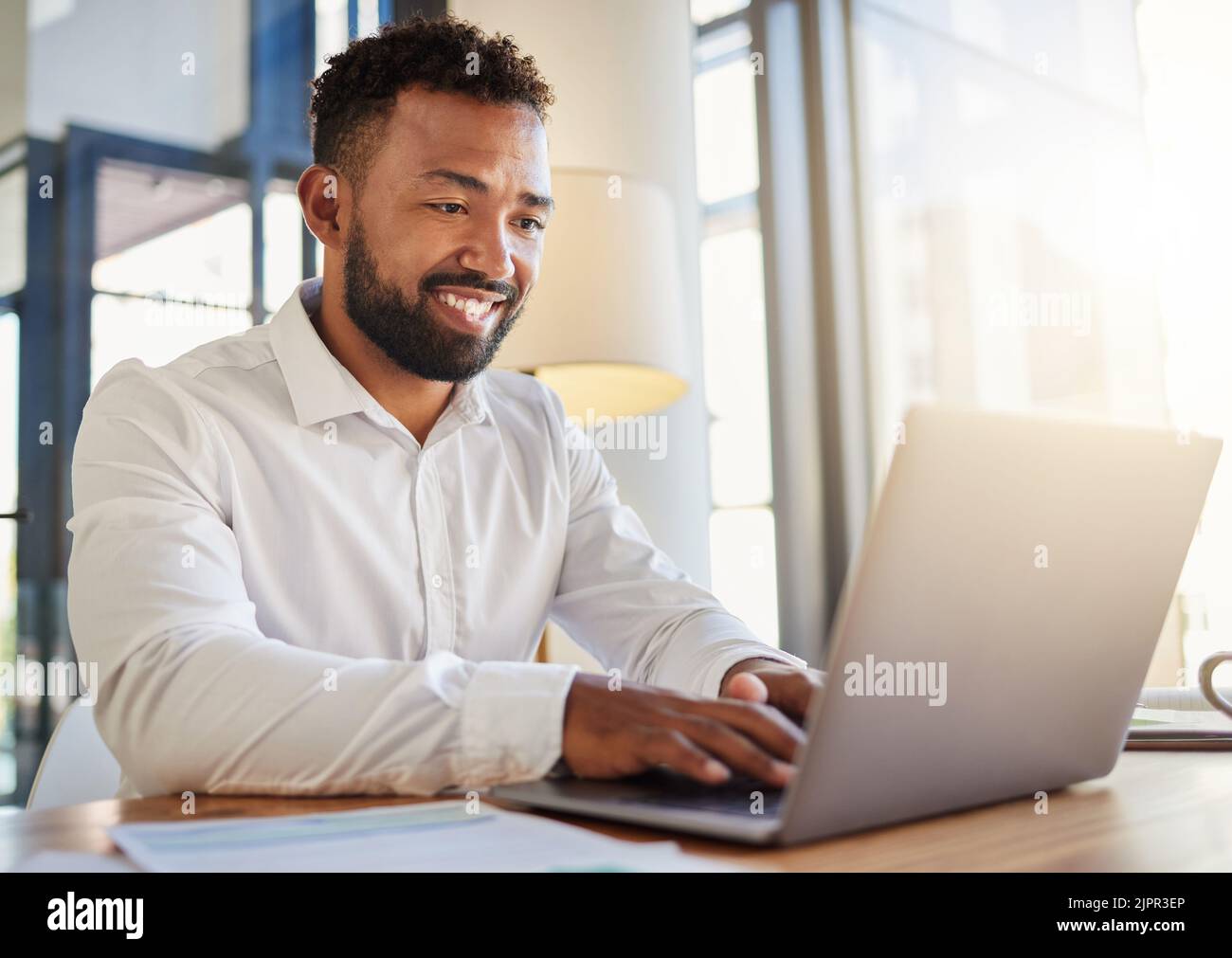 Laptop, business and technology with a corporate man at work on a computer at his desk in an office. Innovation, mission and vision with an employee Stock Photo