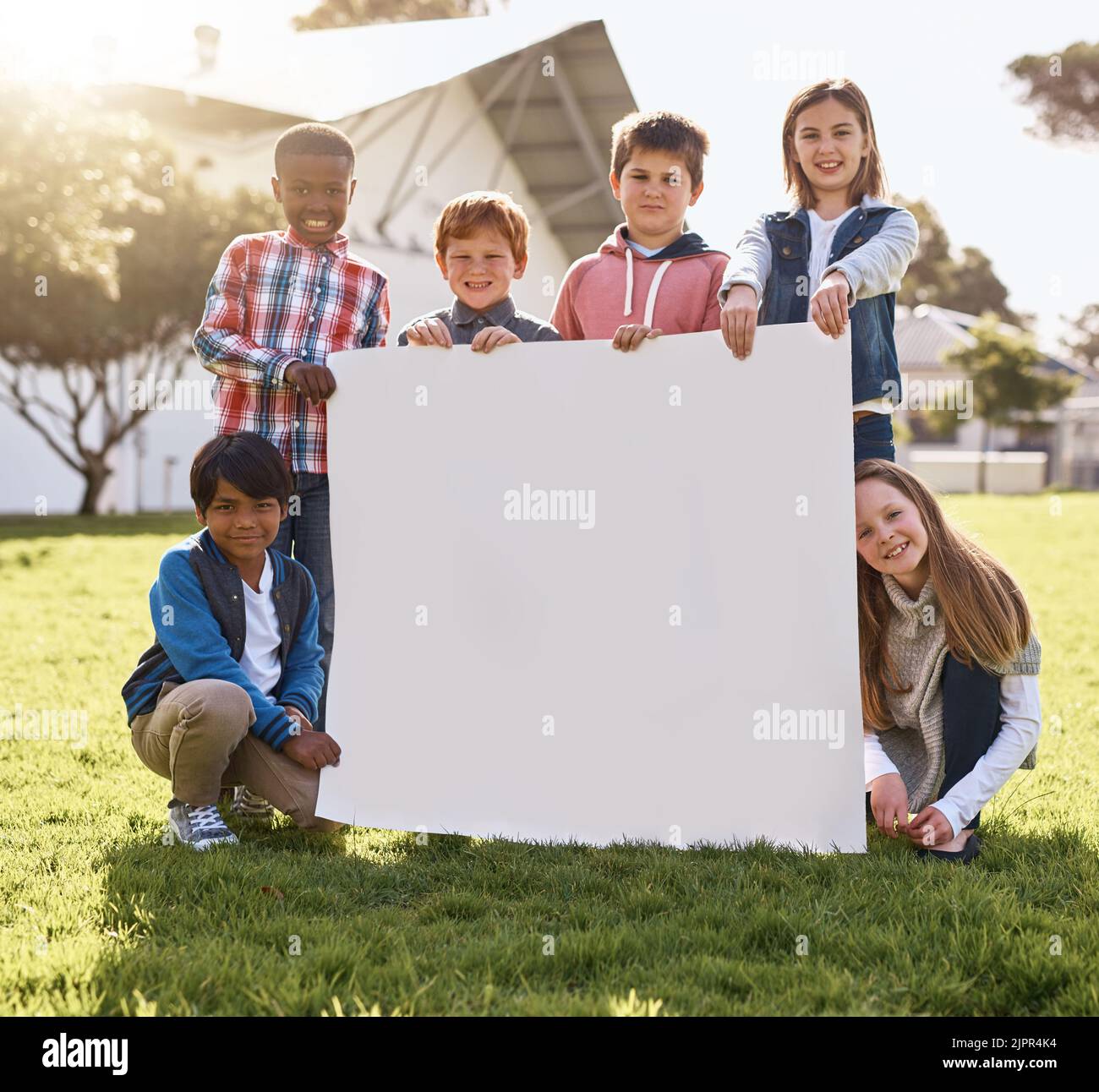 Let the kids advertise your idea for you. young kids playing together outdoors. Stock Photo