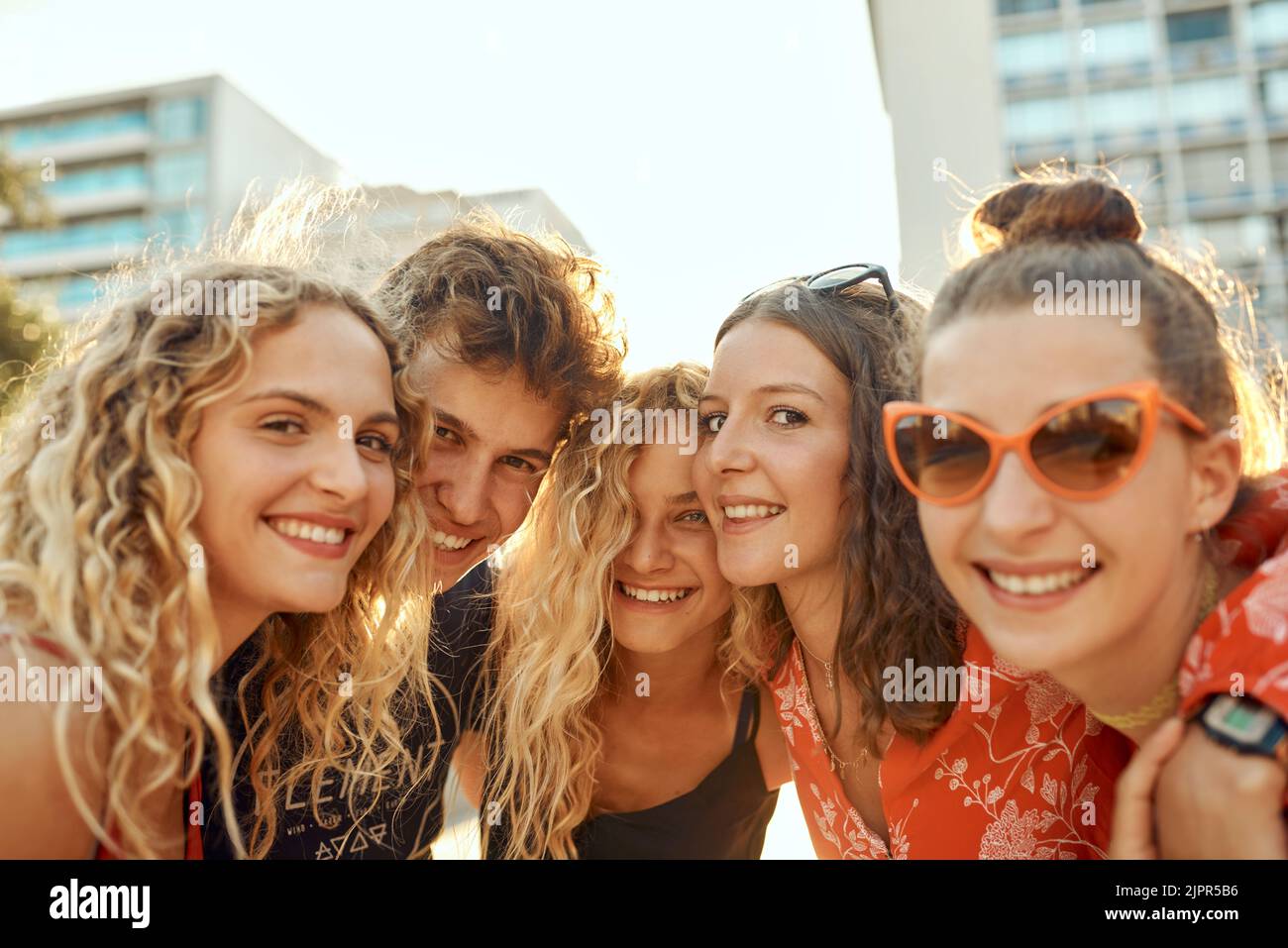 Were just a bunch of young city slickers. Cropped portrait of a group of young friends having a great time out in the city. Stock Photo