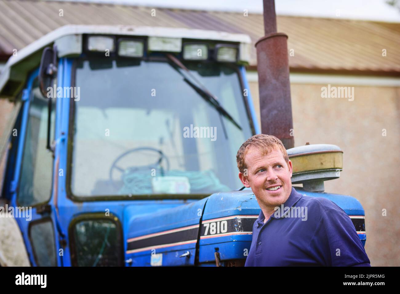 Farmer standing next to a tractor hi-res stock photography and images ...