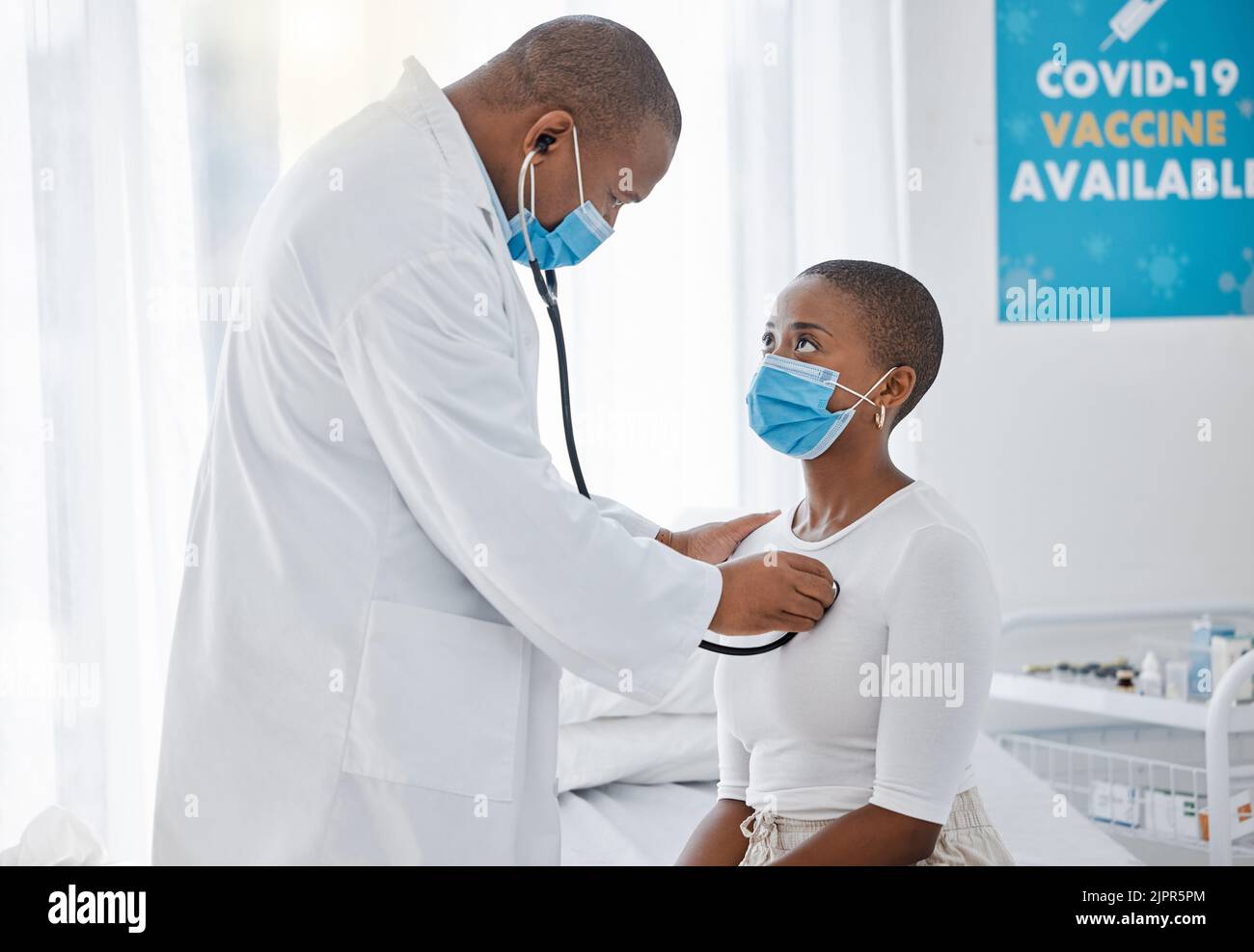 Doctor listening to heartbeat of covid patient, breathing and lungs with stethoscope for healthcare checkup, test and consulting in clinic. Medical Stock Photo