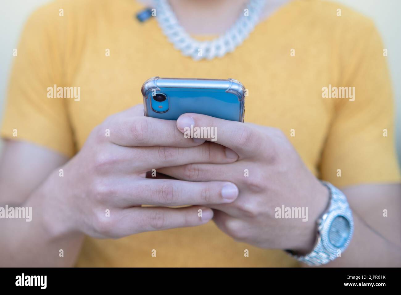 Closeup of happy young man using modern smartphone device - Hipster guy typing sms message on phone - Selective Focus Stock Photo