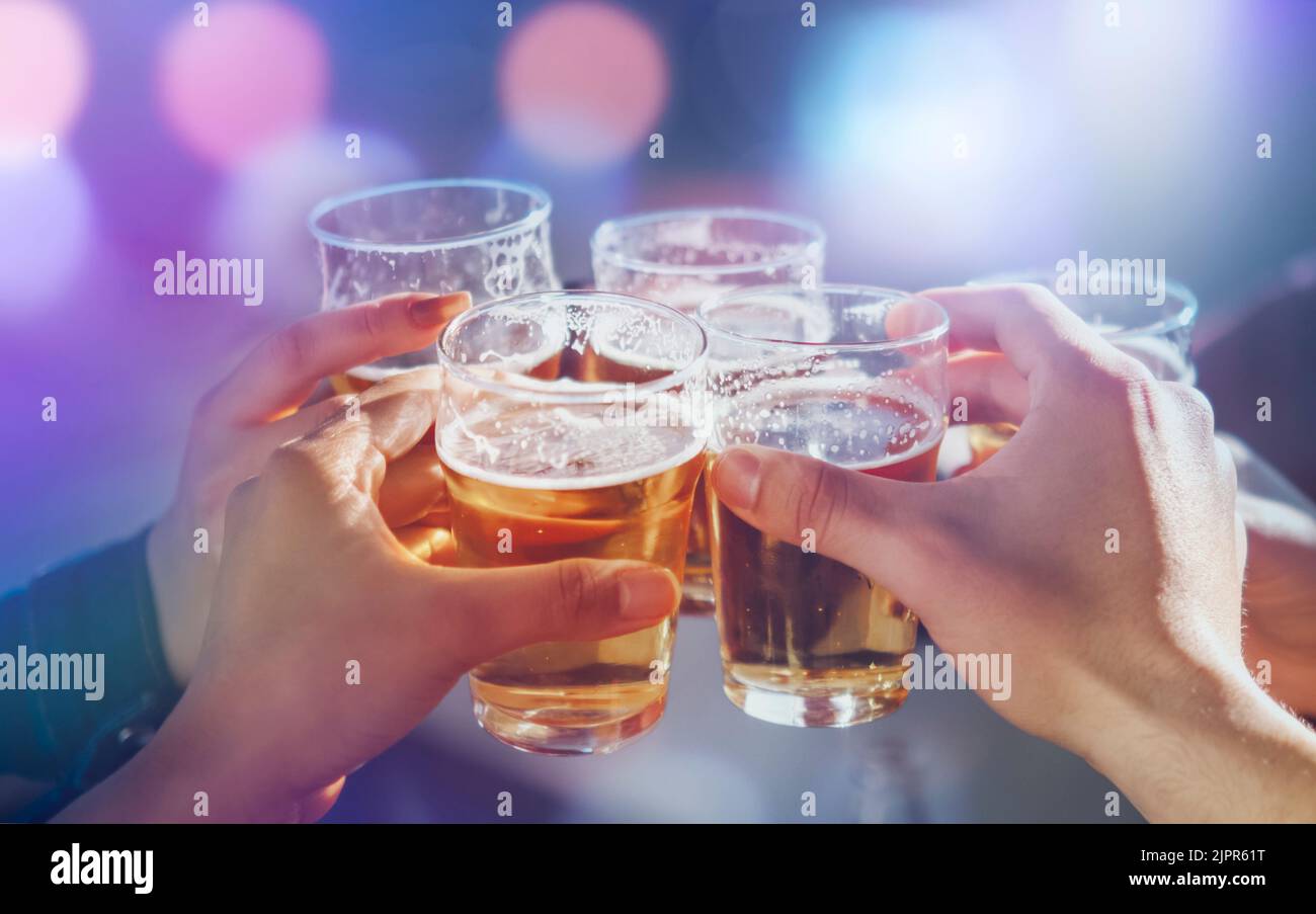 Friends group toasting beers at nightclub. Best friends partying together - Nightlife and Party time concept Stock Photo