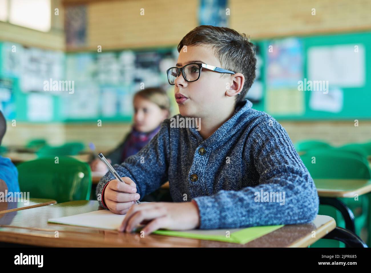 Education is the most powerful in shaping young minds. an elementary school boy working in class. Stock Photo