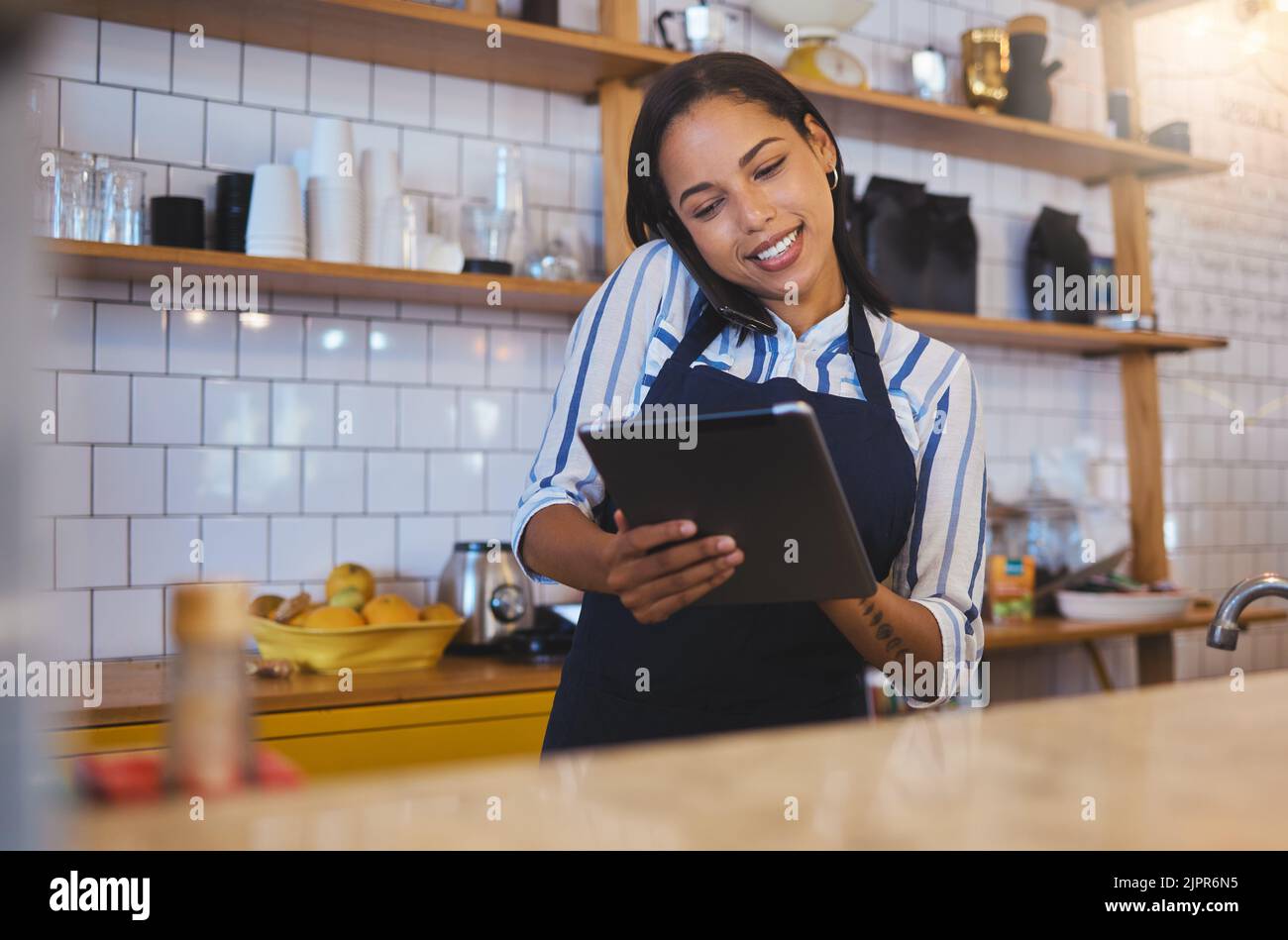Restaurant worker on tablet, phone call and making food payment, delivery or crm conversation with a customer. Business owner or manager of fast food Stock Photo
