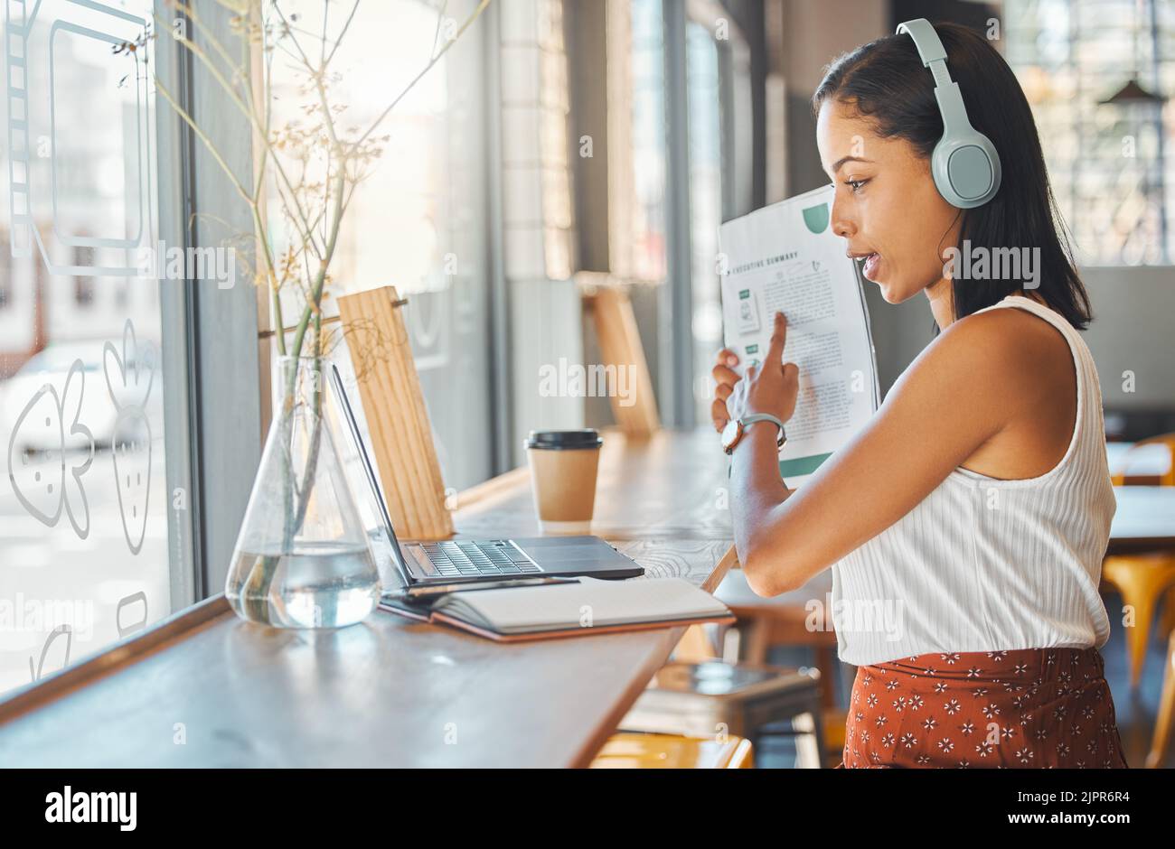 Laptop conference, workshop meeting or training on online zoom call in cafe, restaurant or coffee shop. Remote freelance woman with paper report on Stock Photo