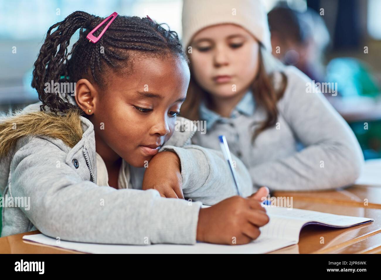 Learning from each other. elementary school girls doing school work