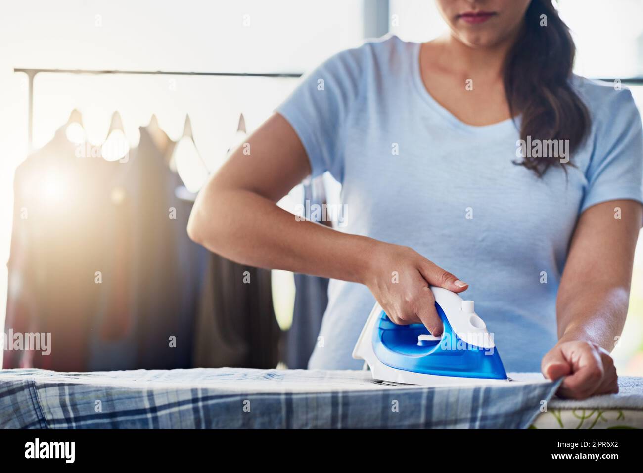Getting straight to ironing. an unrecognizable woman doing her daily ...