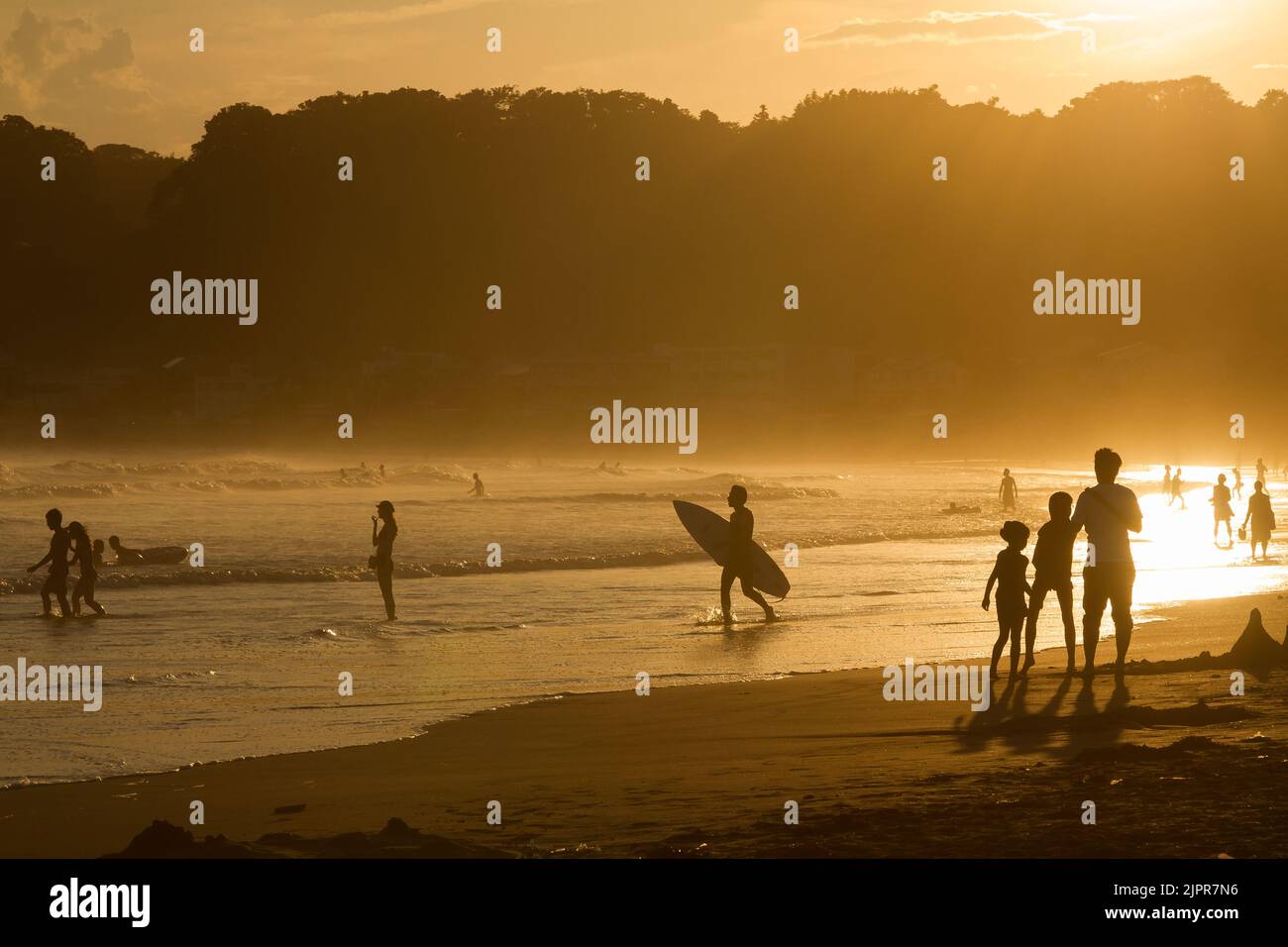 Silhouettes of people enjoying the evening on Kamakura beach. Kanagawa, Japan. Stock Photo