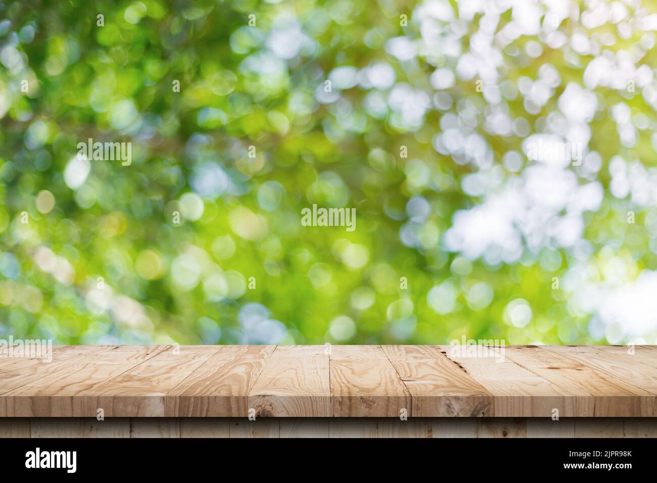 green leaf bokeh blurred and wood table for nature background Stock Photo