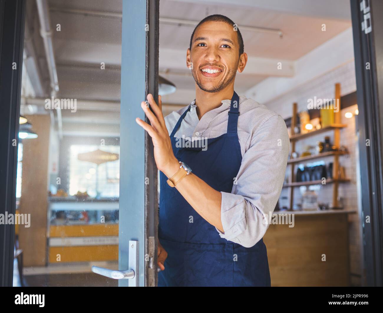 Opening store, entrance door and to cafe, coffee shop or small business. Happy male