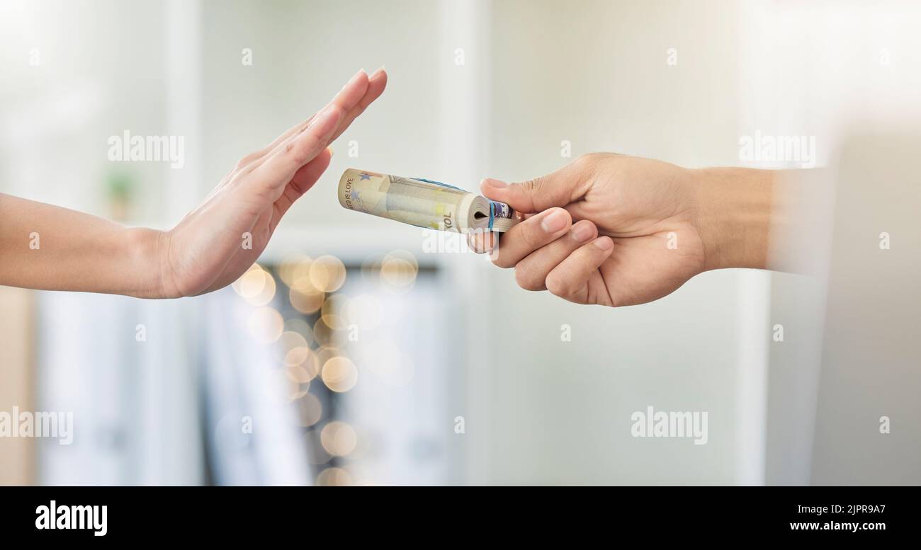.Person refusing to accept a cash bribe payment from a corrupt financial business partner. Closeup of hands offended by illegal money being offered Stock Photo
