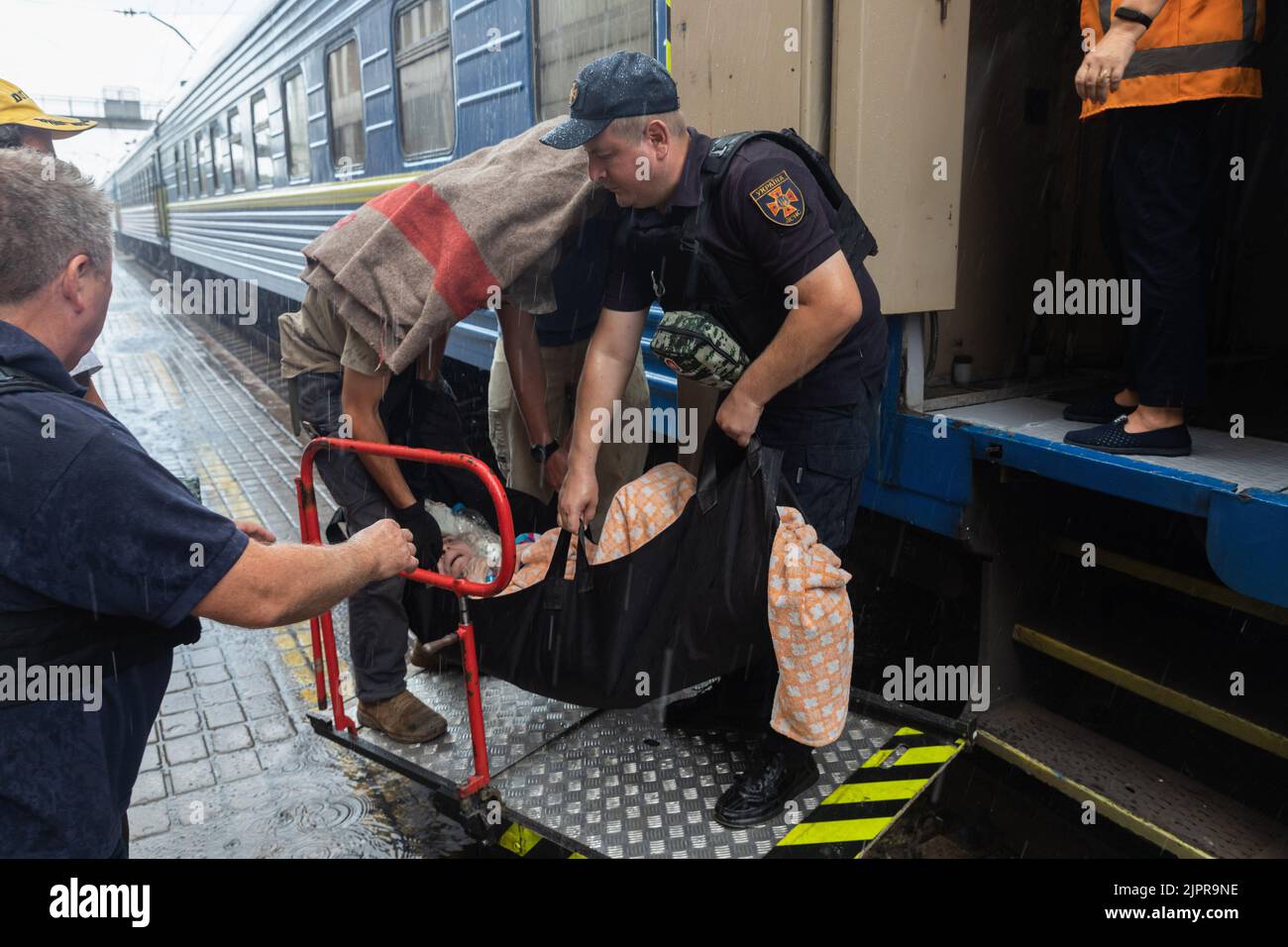 Pokrovsk, Ukraine. 4th Aug, 2022. An employee of the State Emergency Service of Ukraine helps to load an elderly woman with a disability into a train car. Evacuation train from Pokrovsk last railway station in Donetsk region. (Credit Image: © Mykhaylo Palinchak/SOPA Images via ZUMA Press Wire) Stock Photo