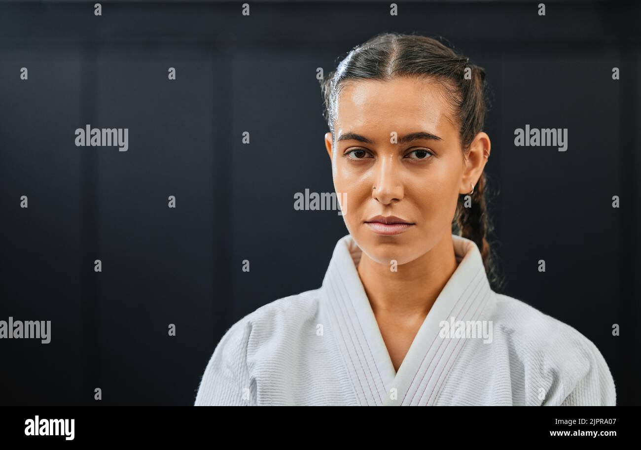 Karate, martial arts or taekwondo woman, coach or trainer with vision, motivation or power in wellness gym. Fitness portrait of serious or fit sport Stock Photo