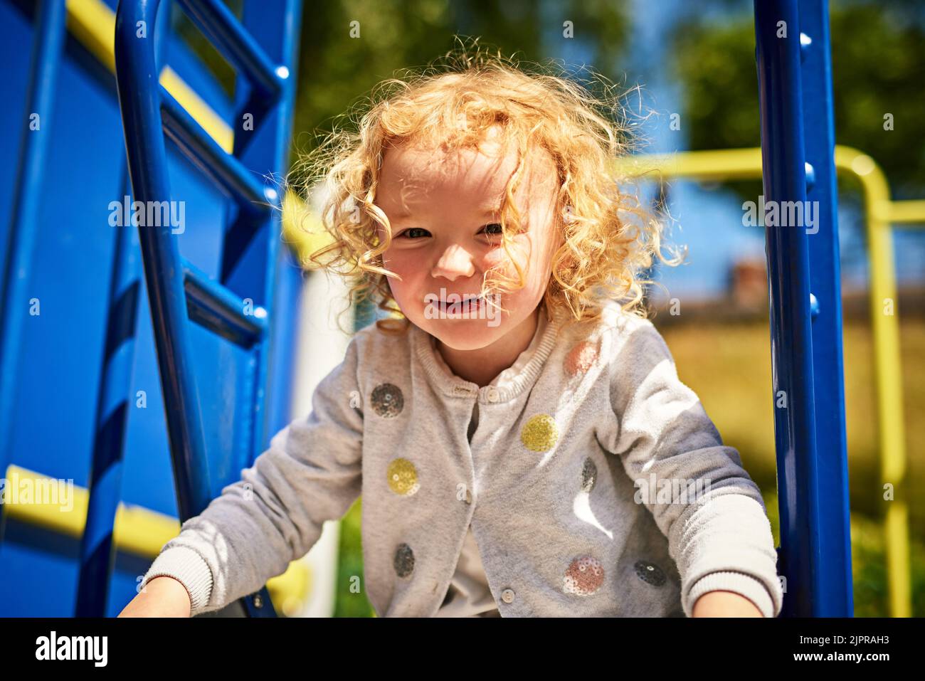 Children discover the world through play. an adorable little girl playing outdoors. Stock Photo