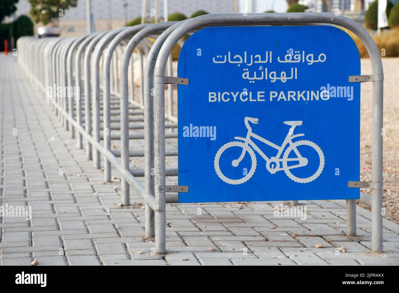 bicycle parking station in street side with sign board in english and